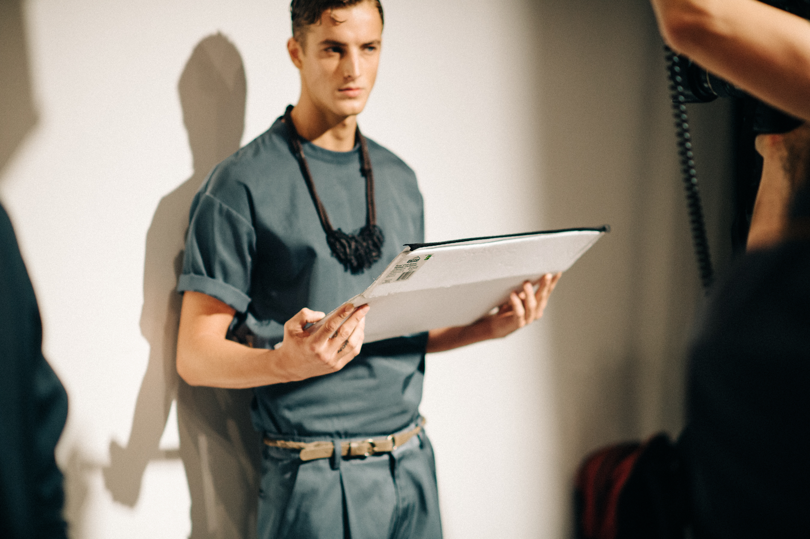 Male model wearing blue before the show
