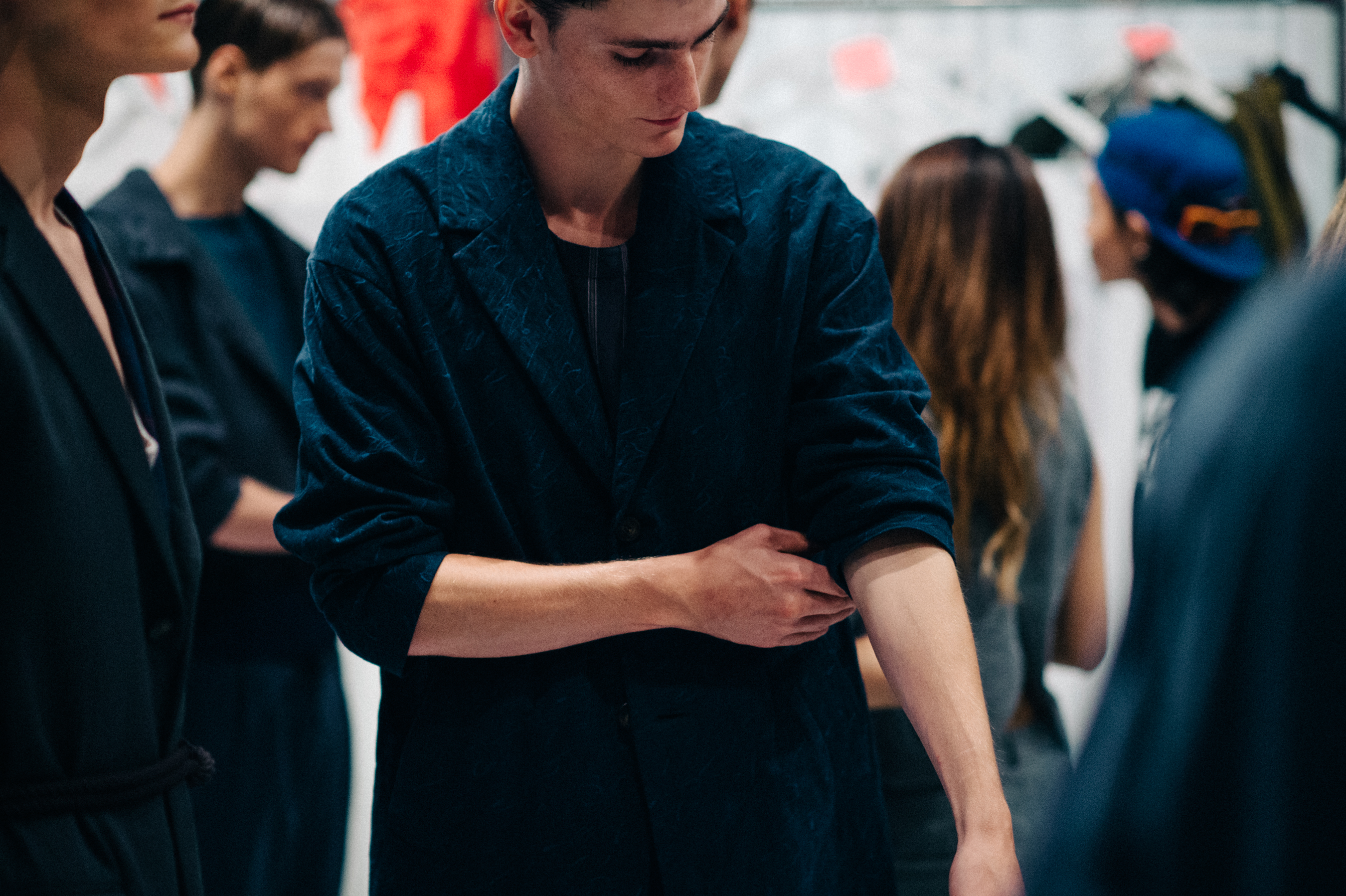 Male model in blue blazer before the show