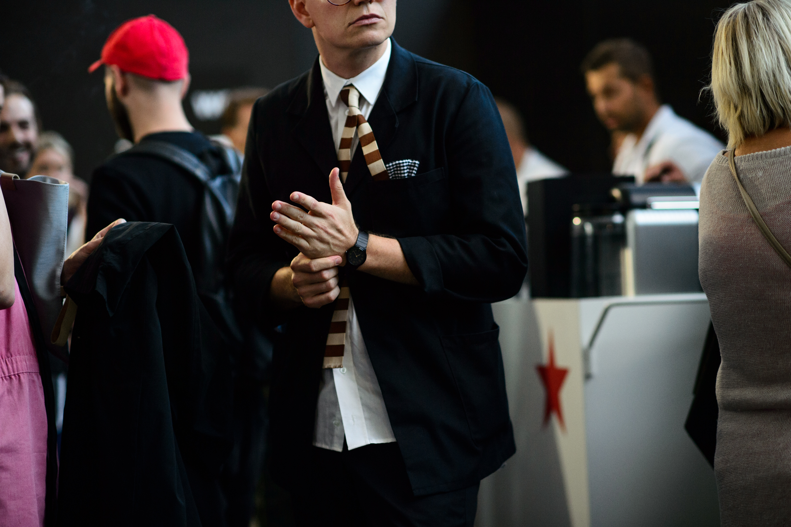 Man wearing striped tie and back watch