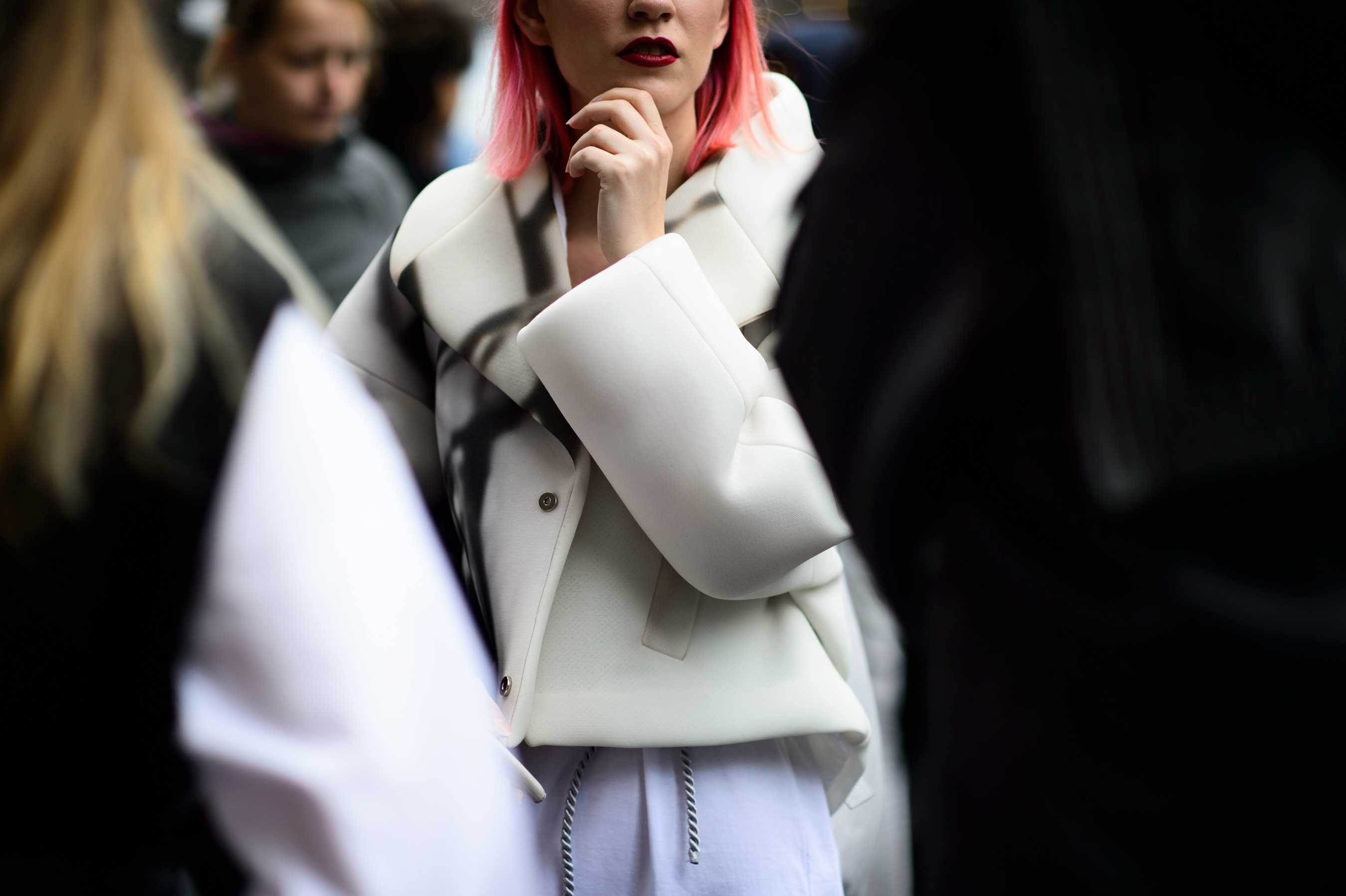 Woman with pink hair in marble printed white jacket