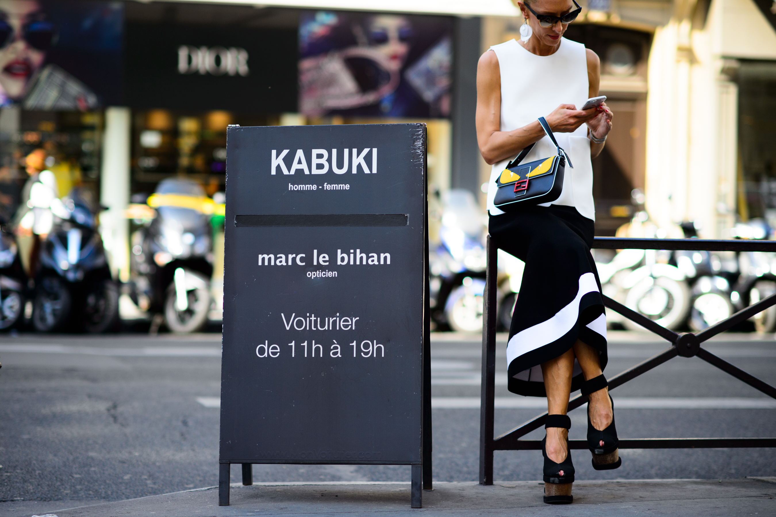 Store owner next to her shop sign