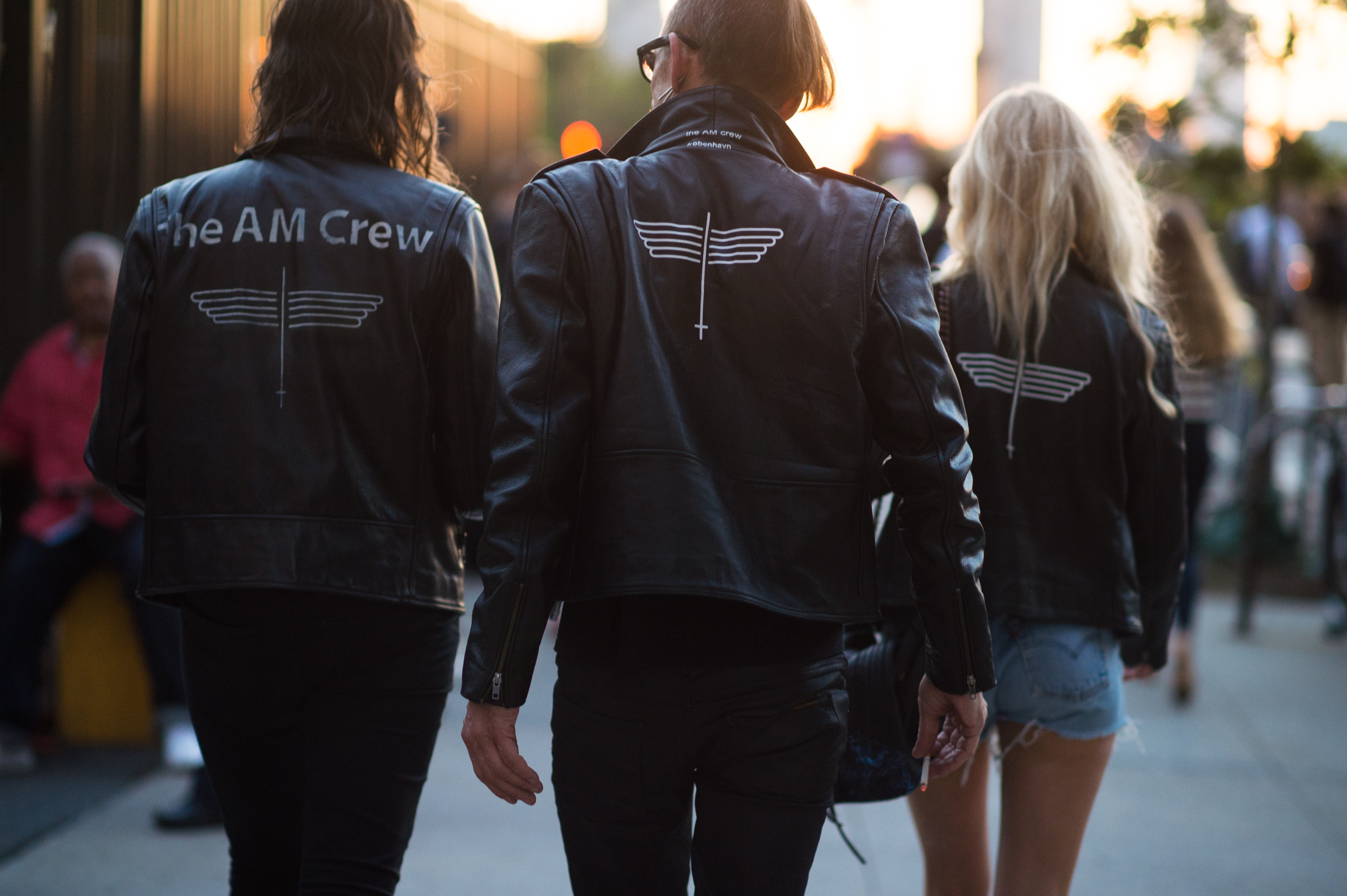 Two guys and a girl wearing biker leather jackets