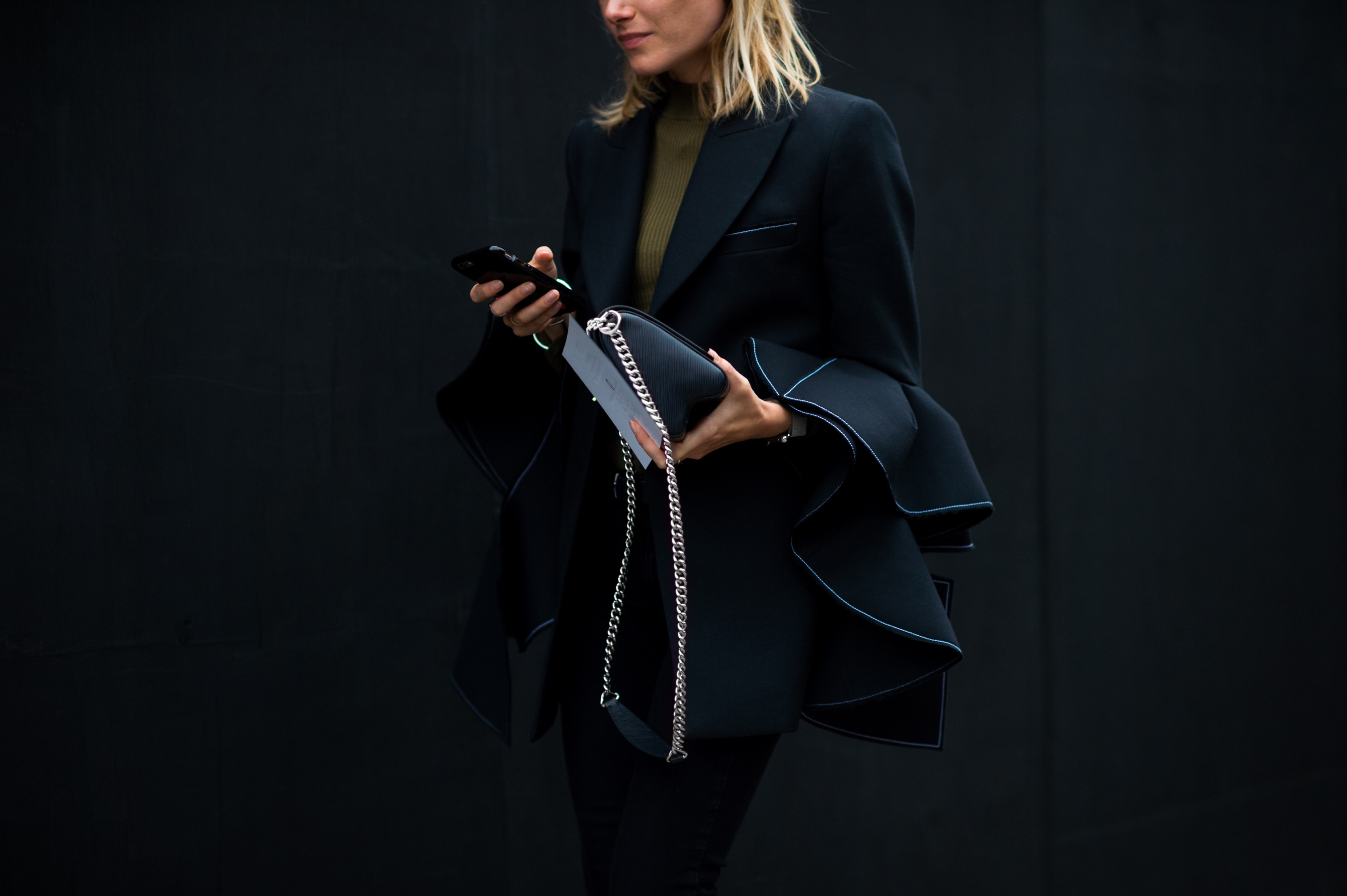 Woman wearing jacket with complex sleeves