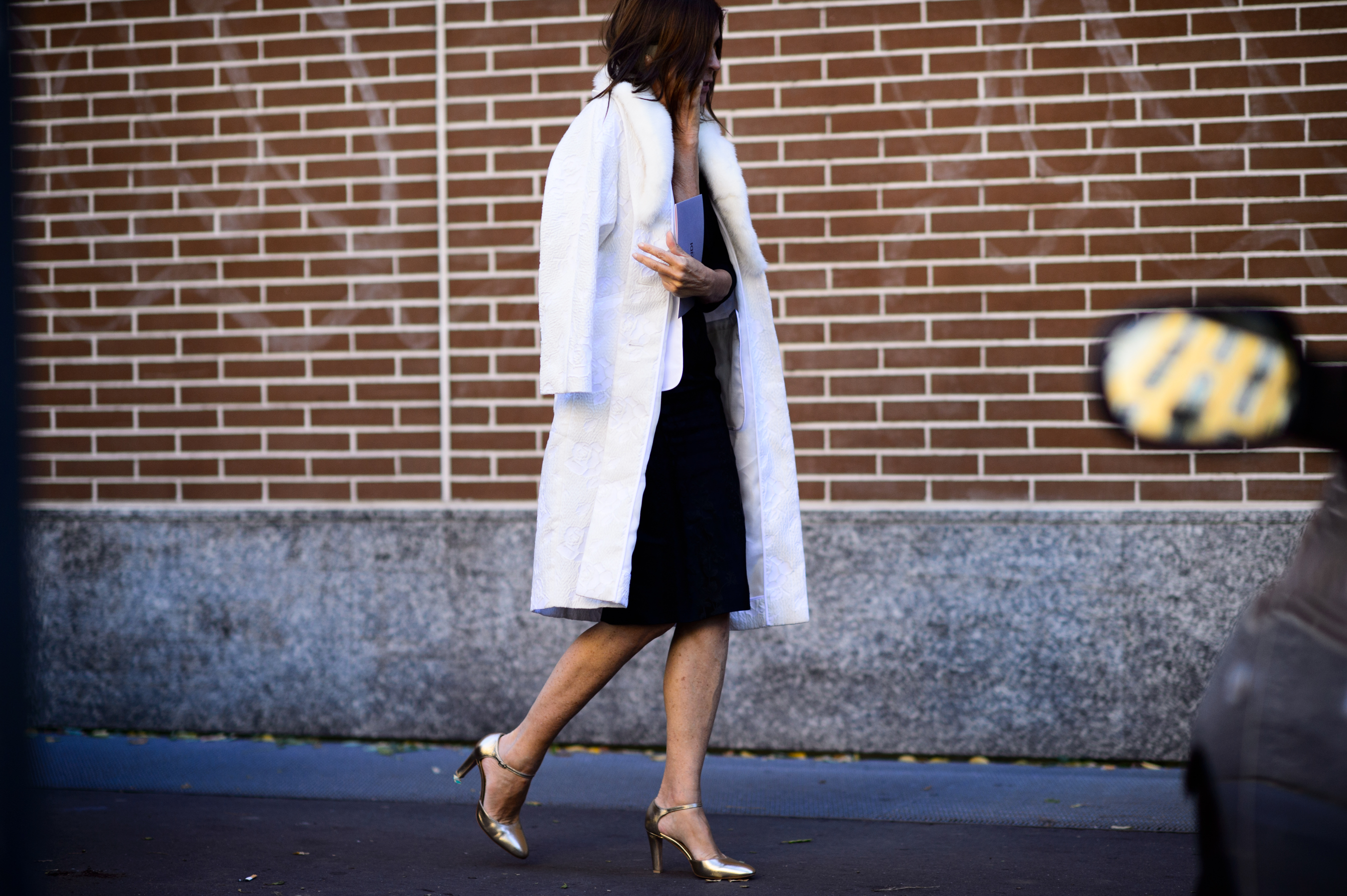 Stylist wearing white coat and shoes before the show