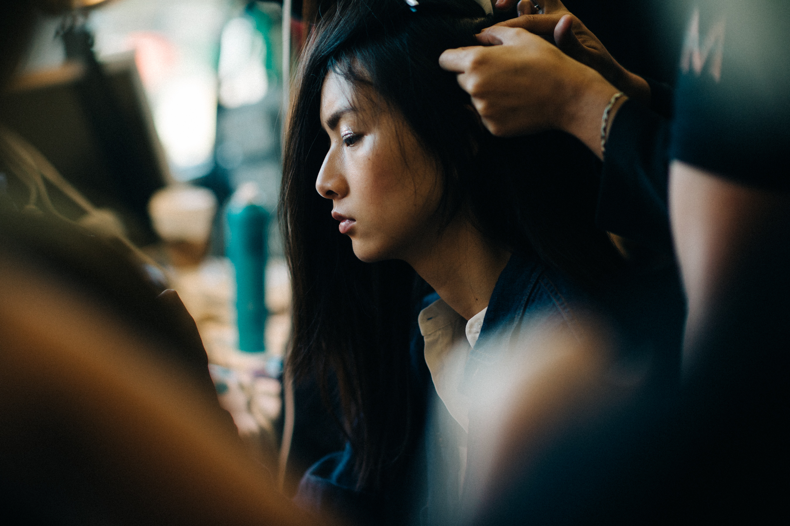 Model getting hair done before the show