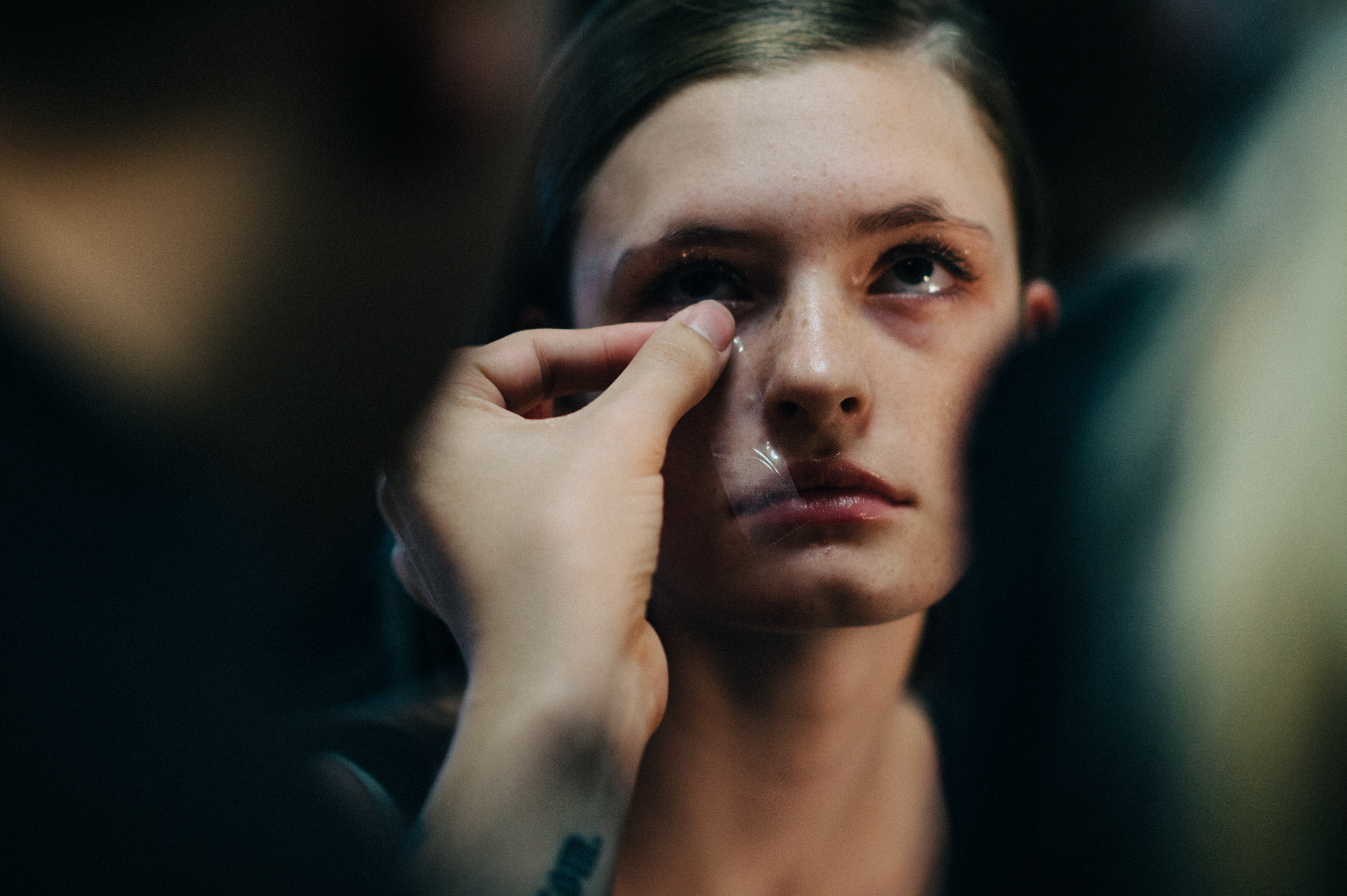 Model is getting make up done using tape