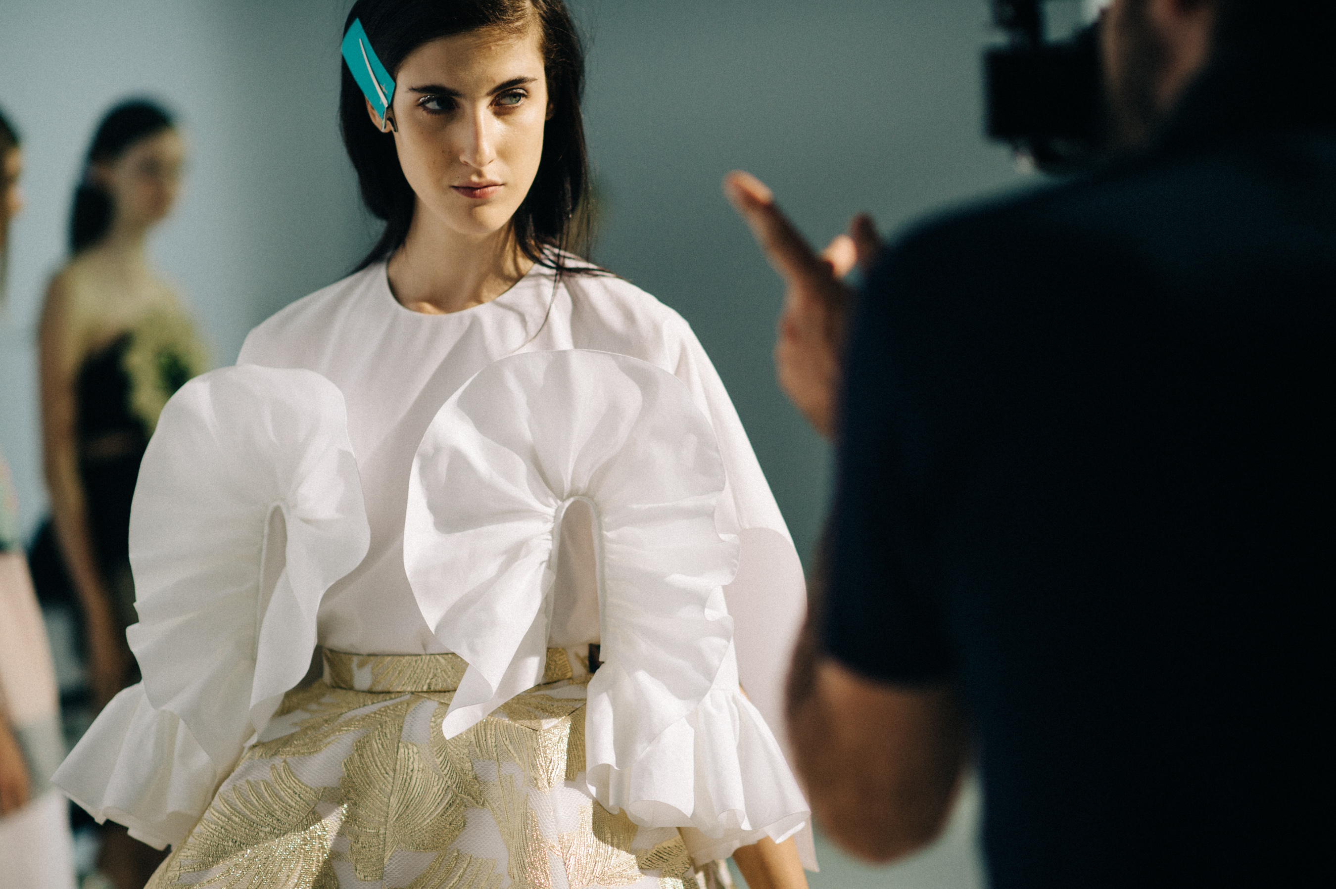 Model dressed in white before the show