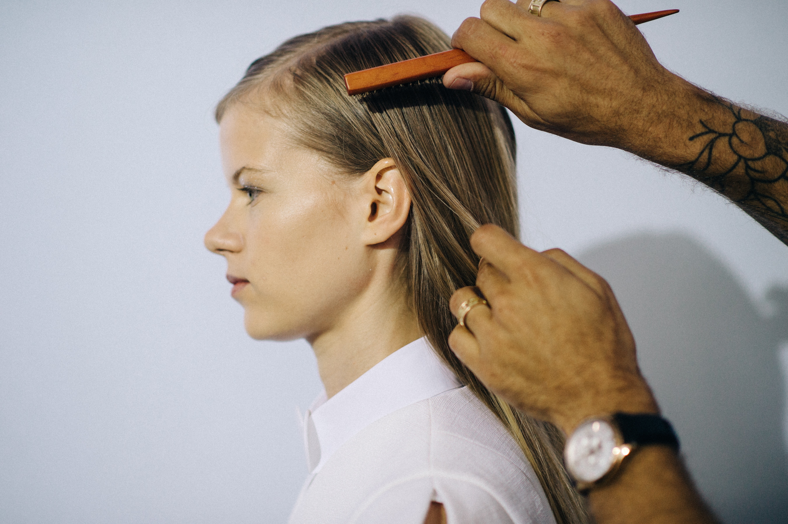 Model getting her hair brushed before the show