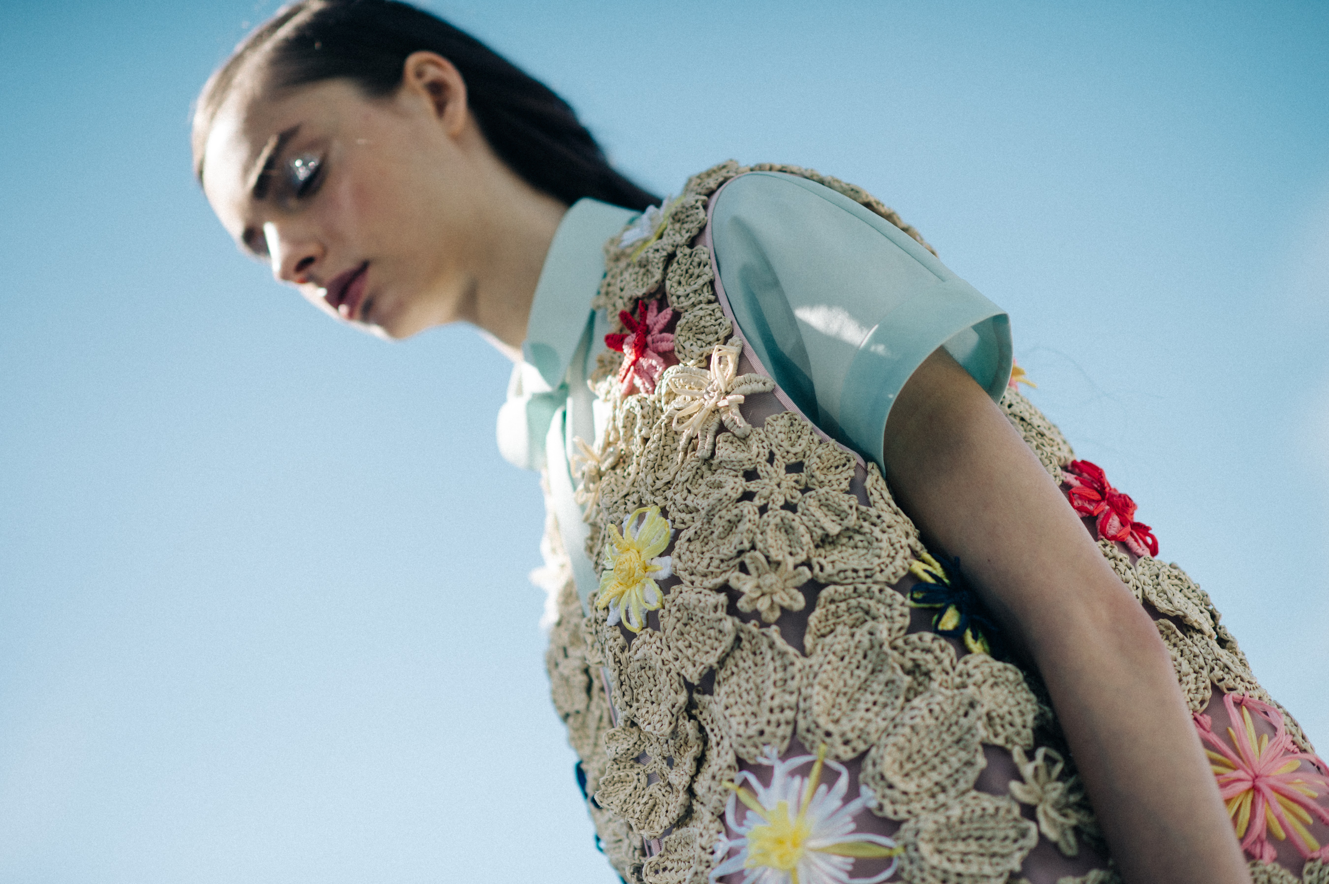 Model wearing blue and embroidered piece