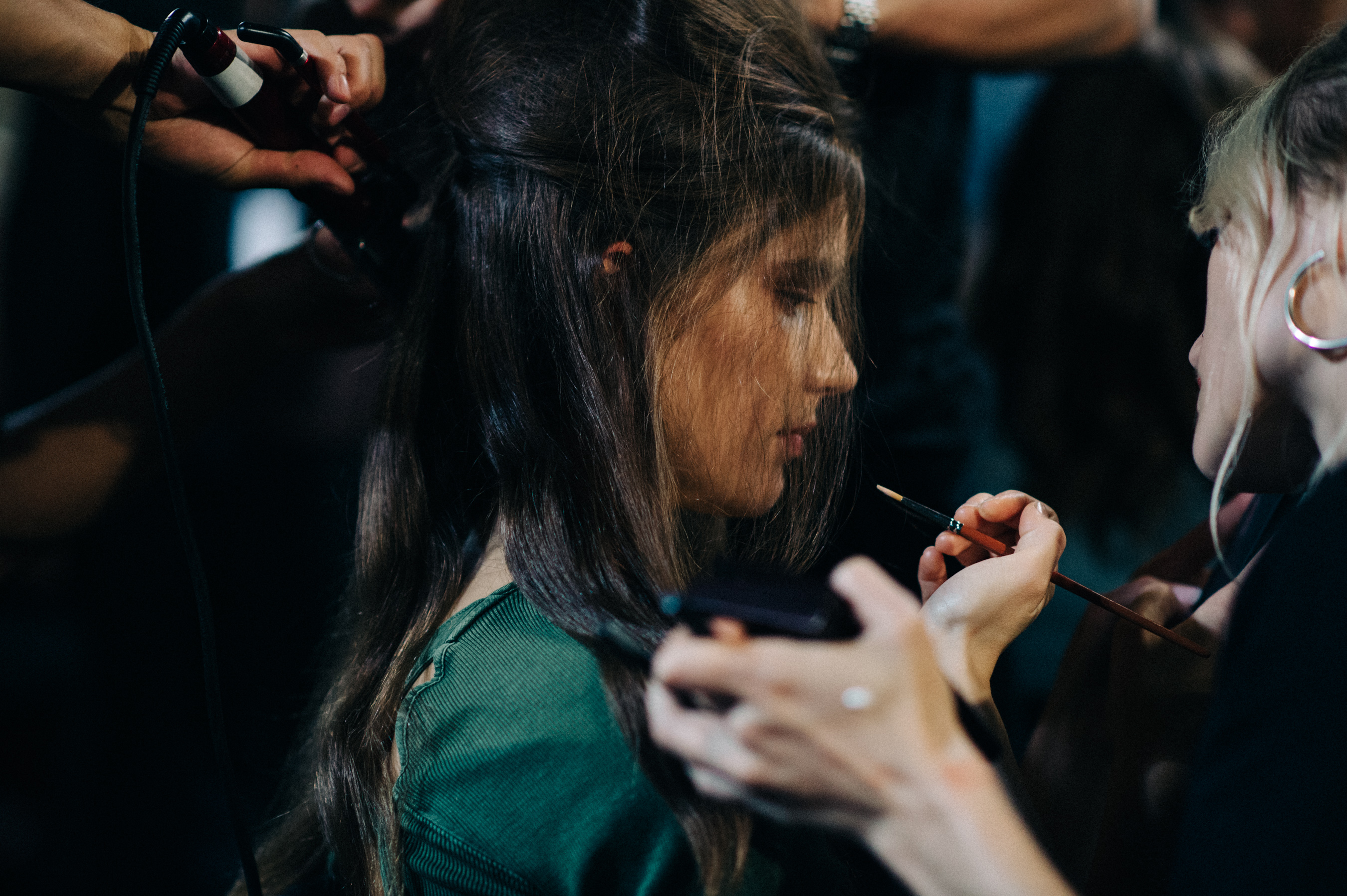 Model getting hair done before the show