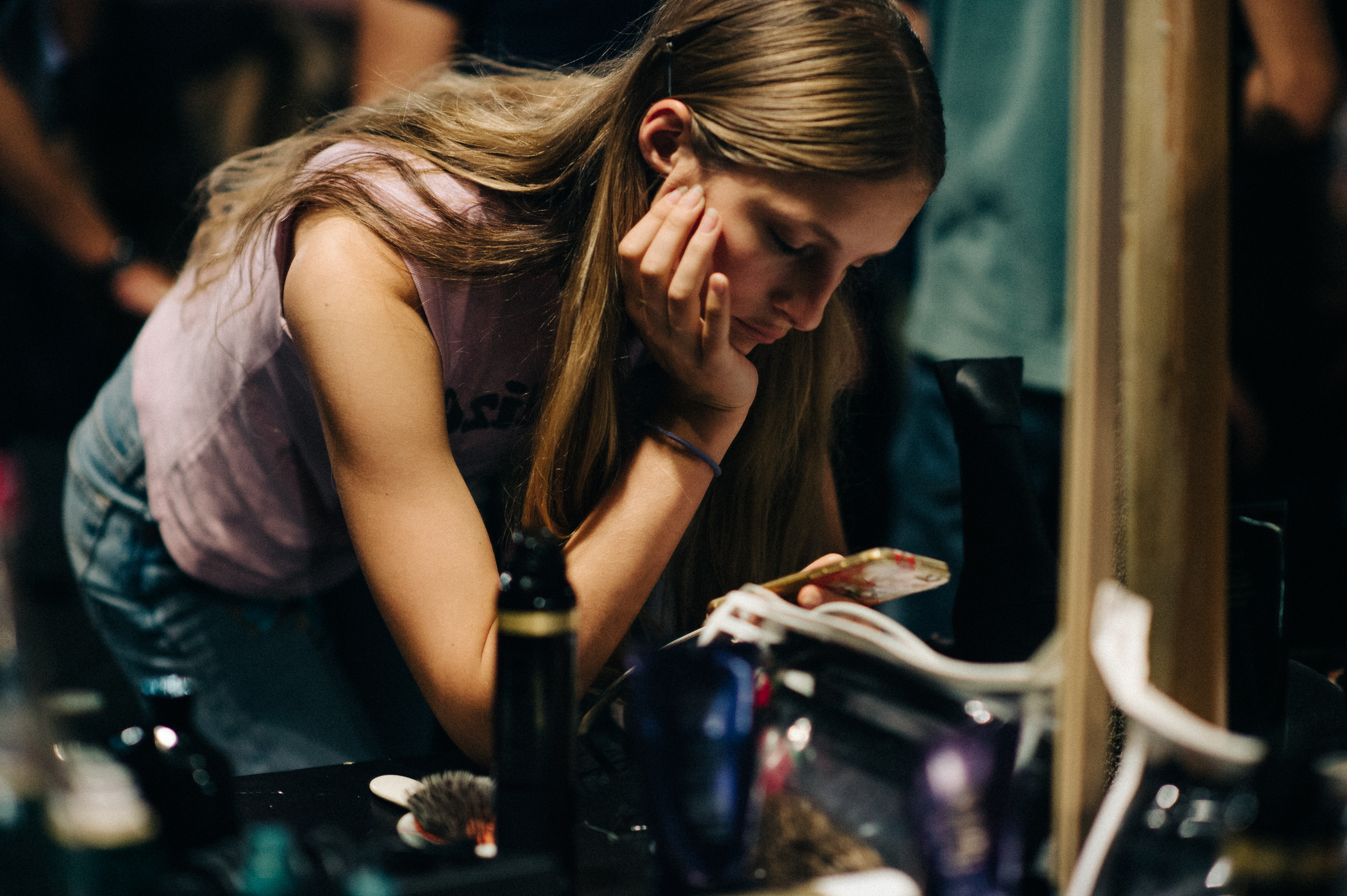 Model on her phone before the fashion show