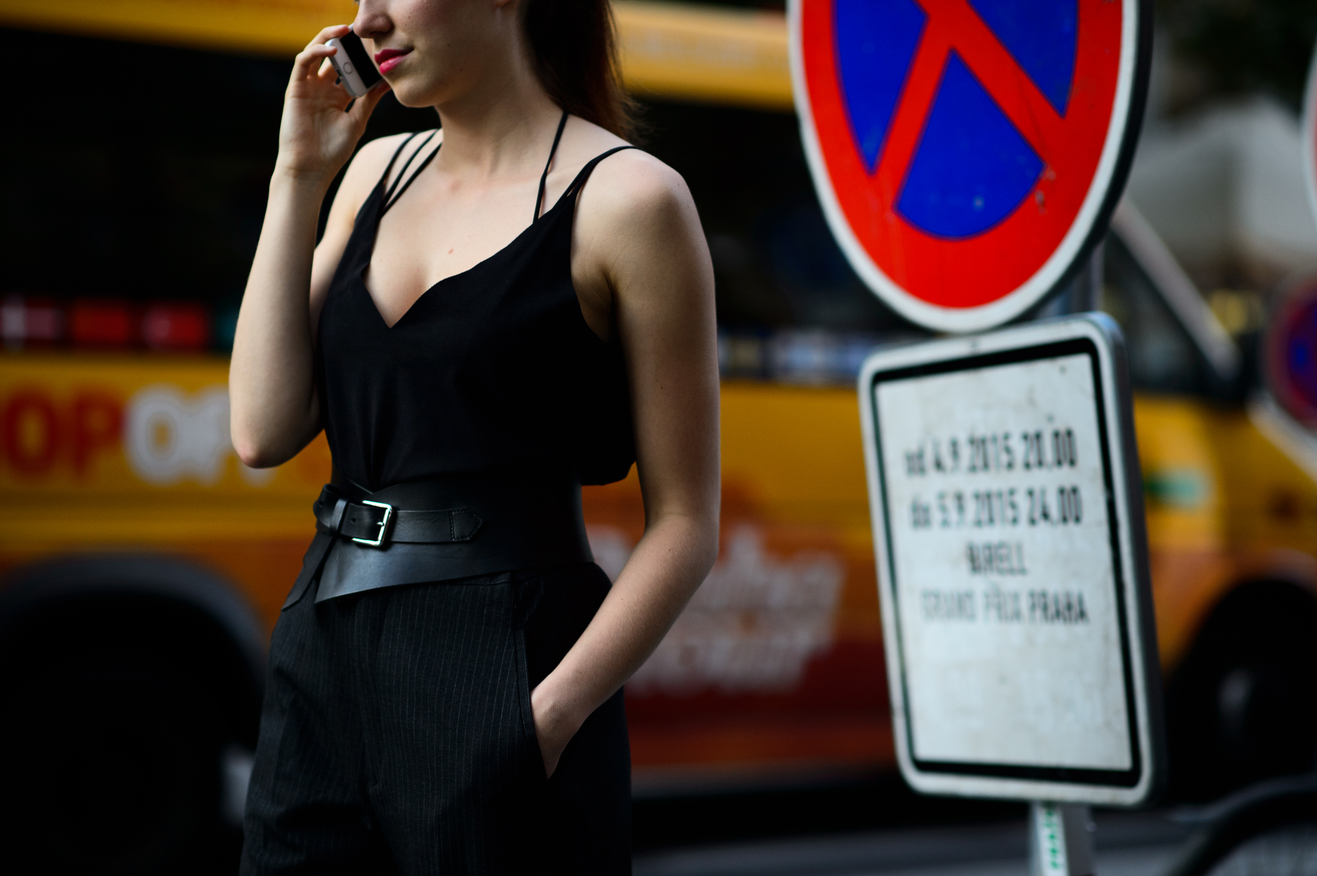 Woman wearing black dress with wide belt