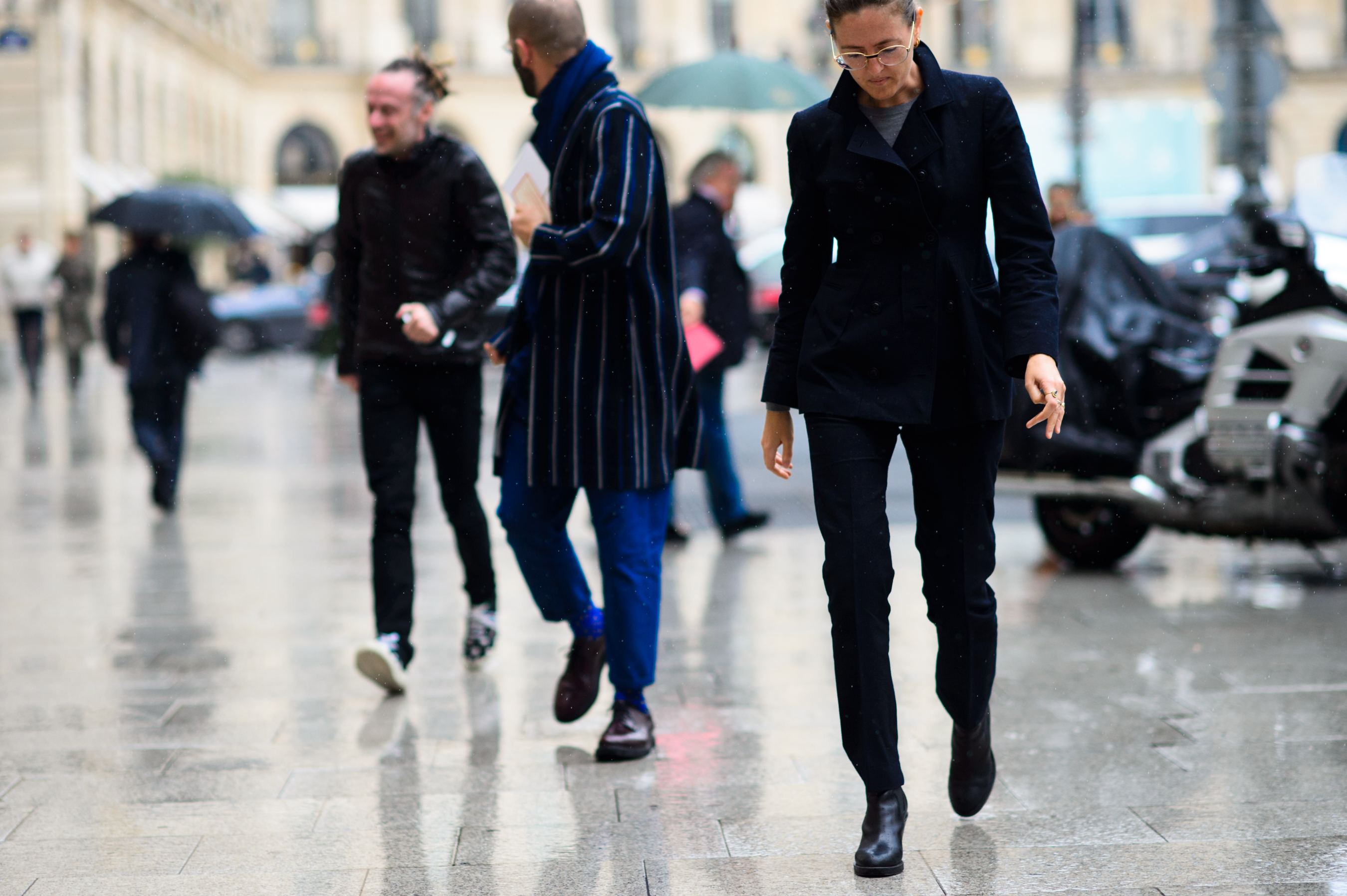One woman and two men walking to the show