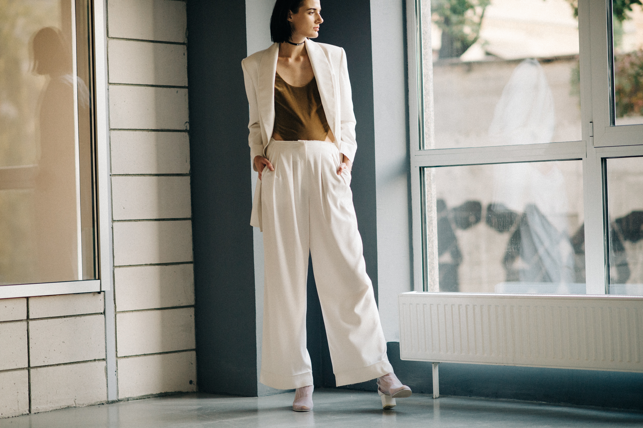 Model wearing white suit before the show