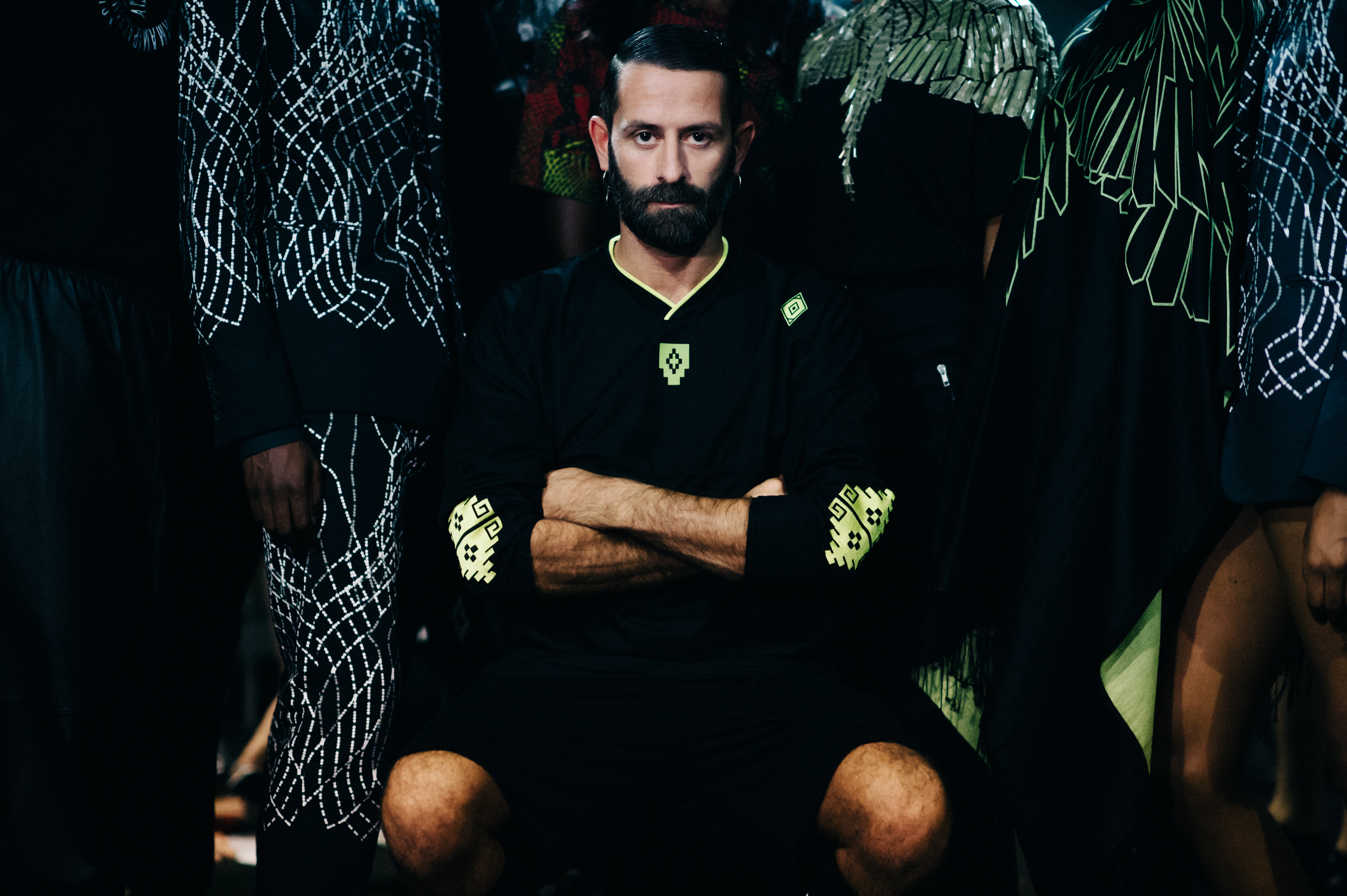 Designer next to his models before the show