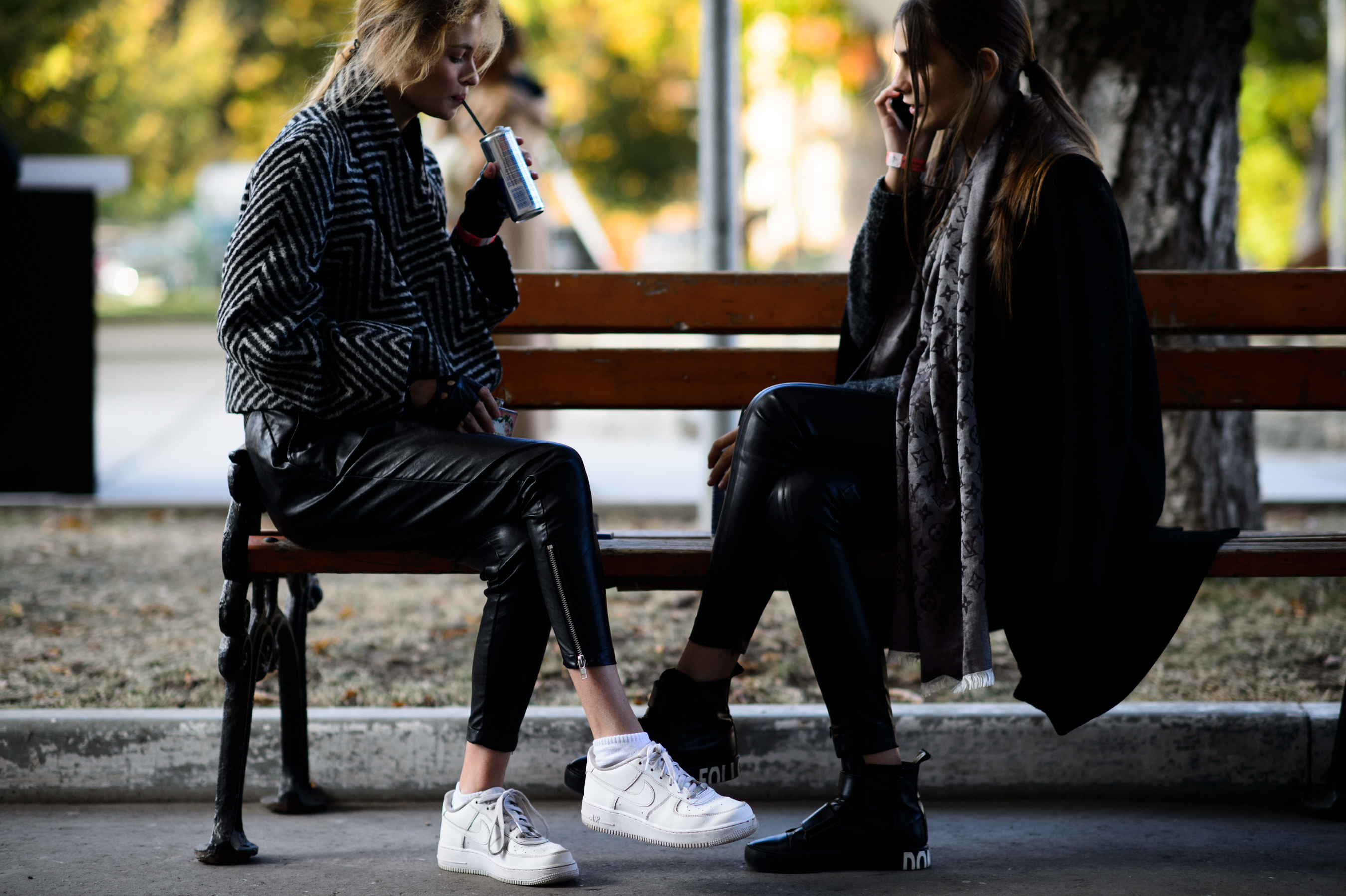 Two models sitting on a bench