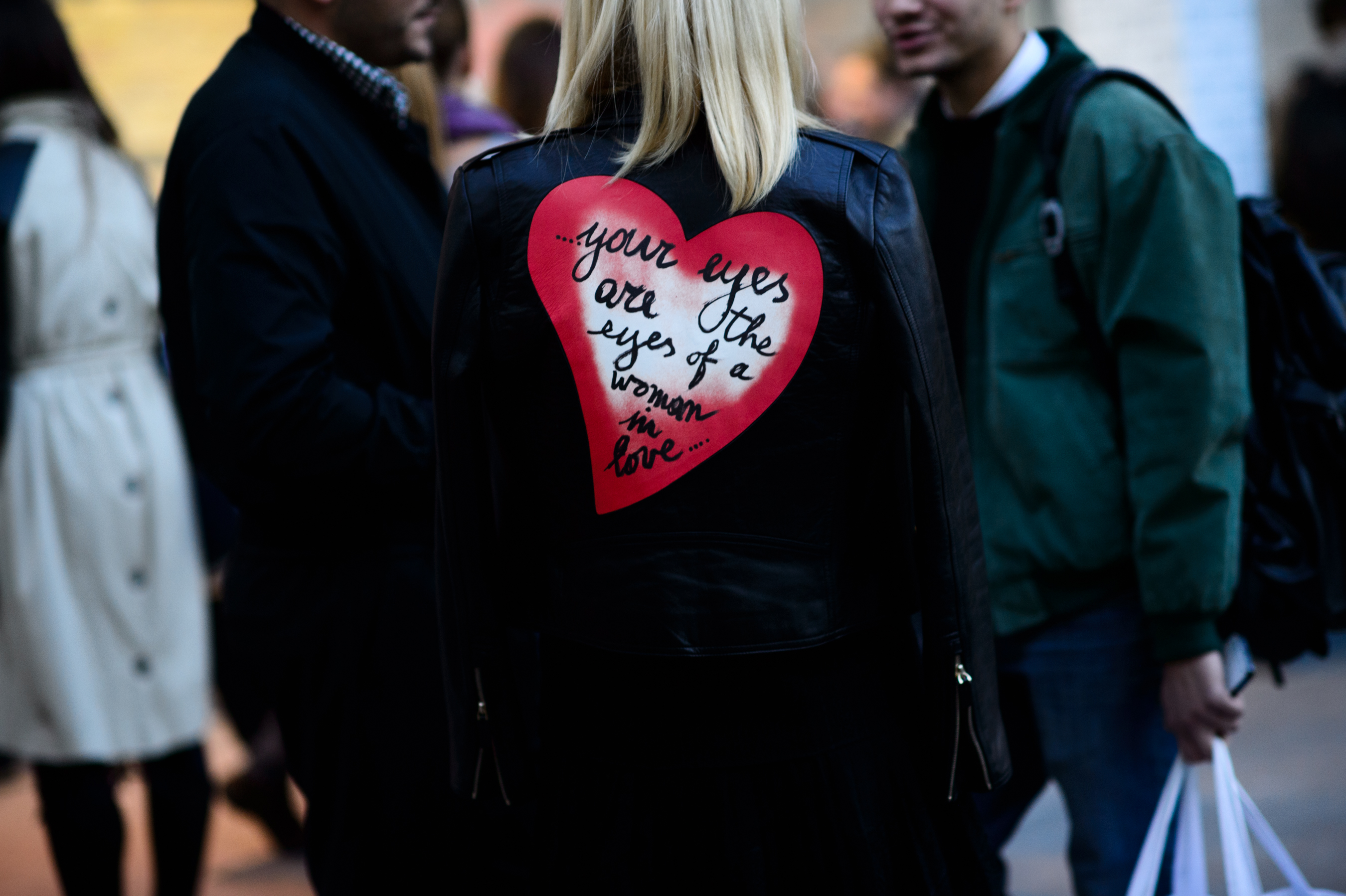 Girl wearing leather jacket with heart printed on it