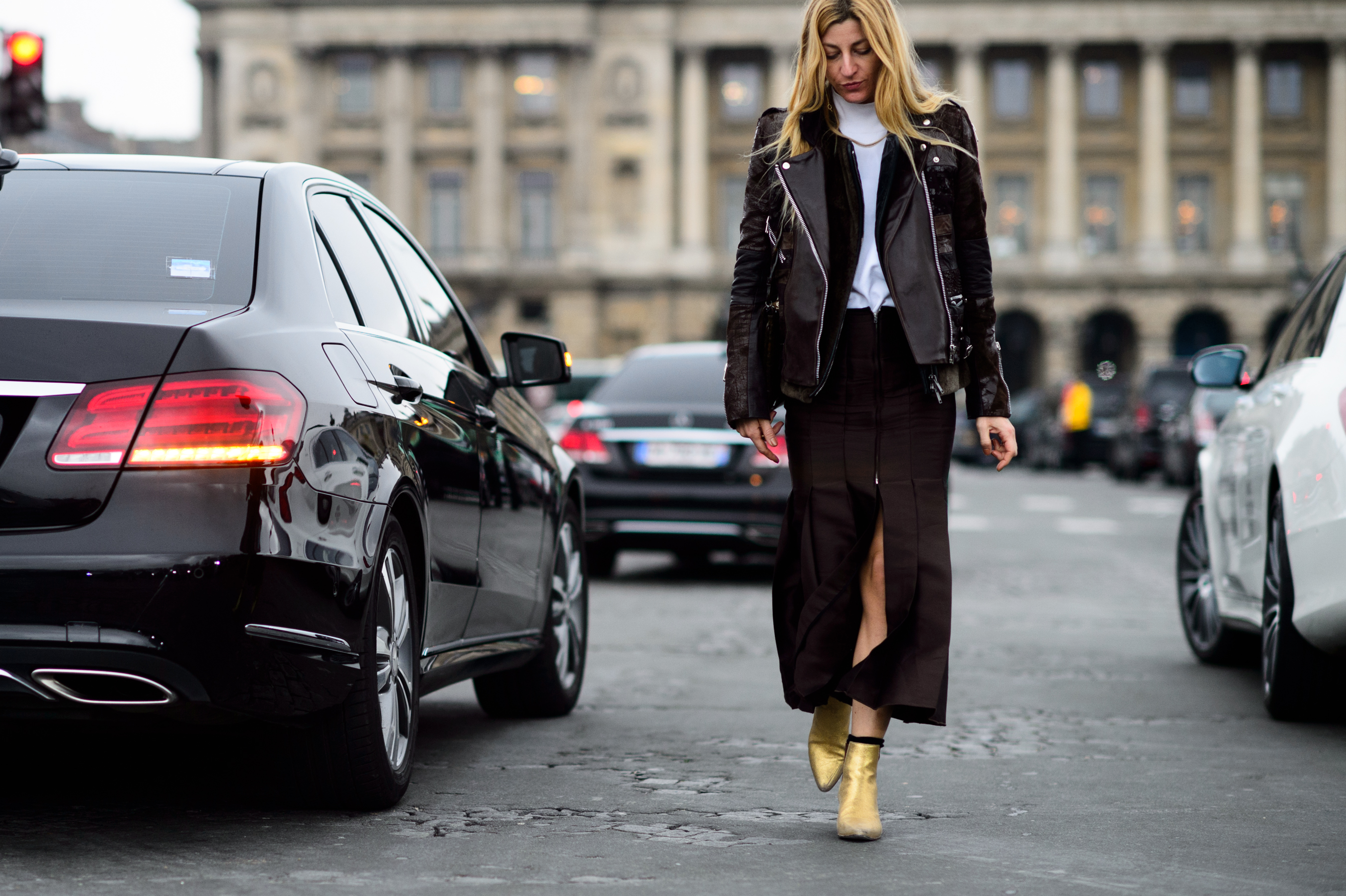 Stylist wearing brown outfit with golden boots