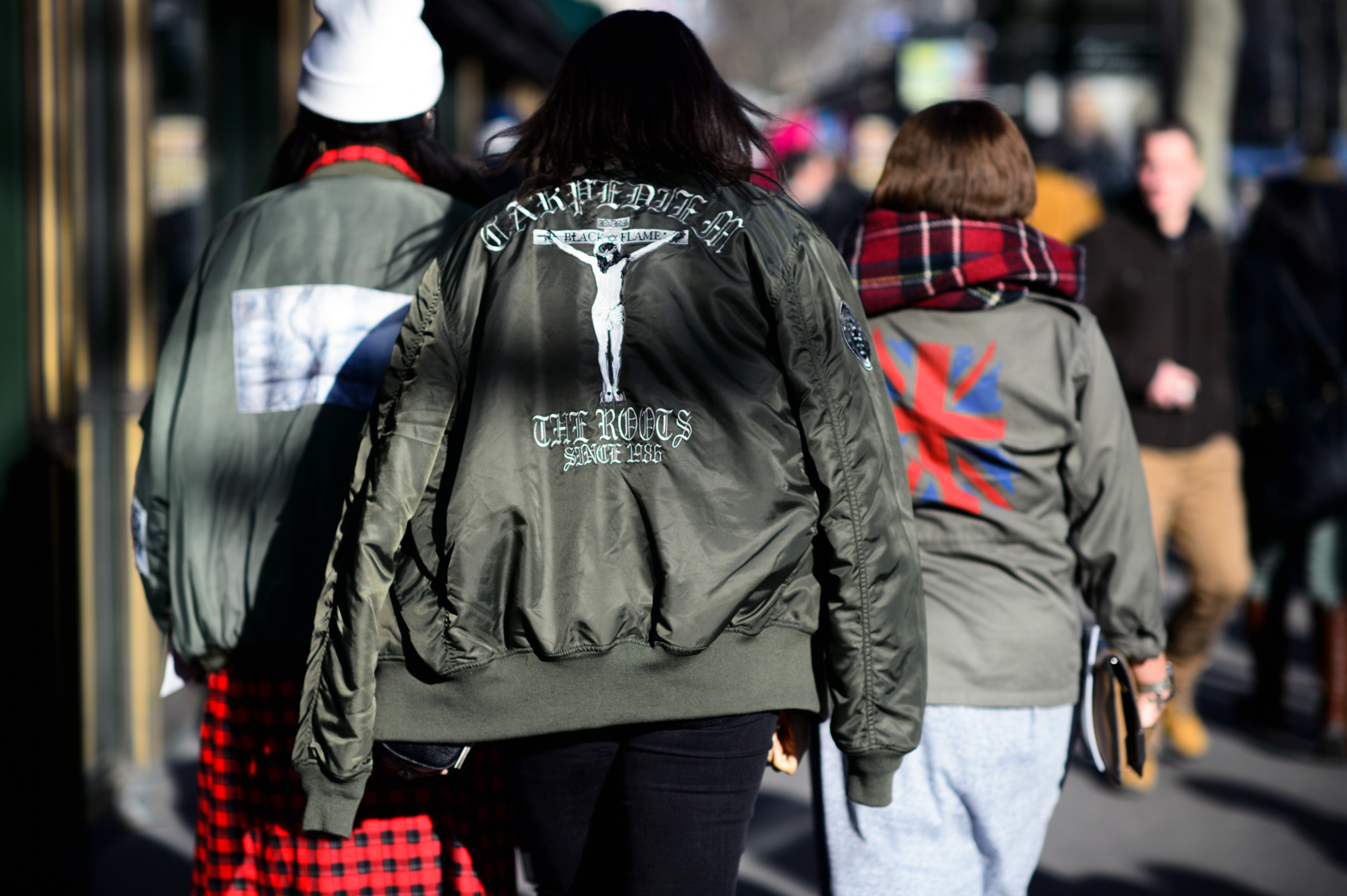 Three women wearing khaki jackets