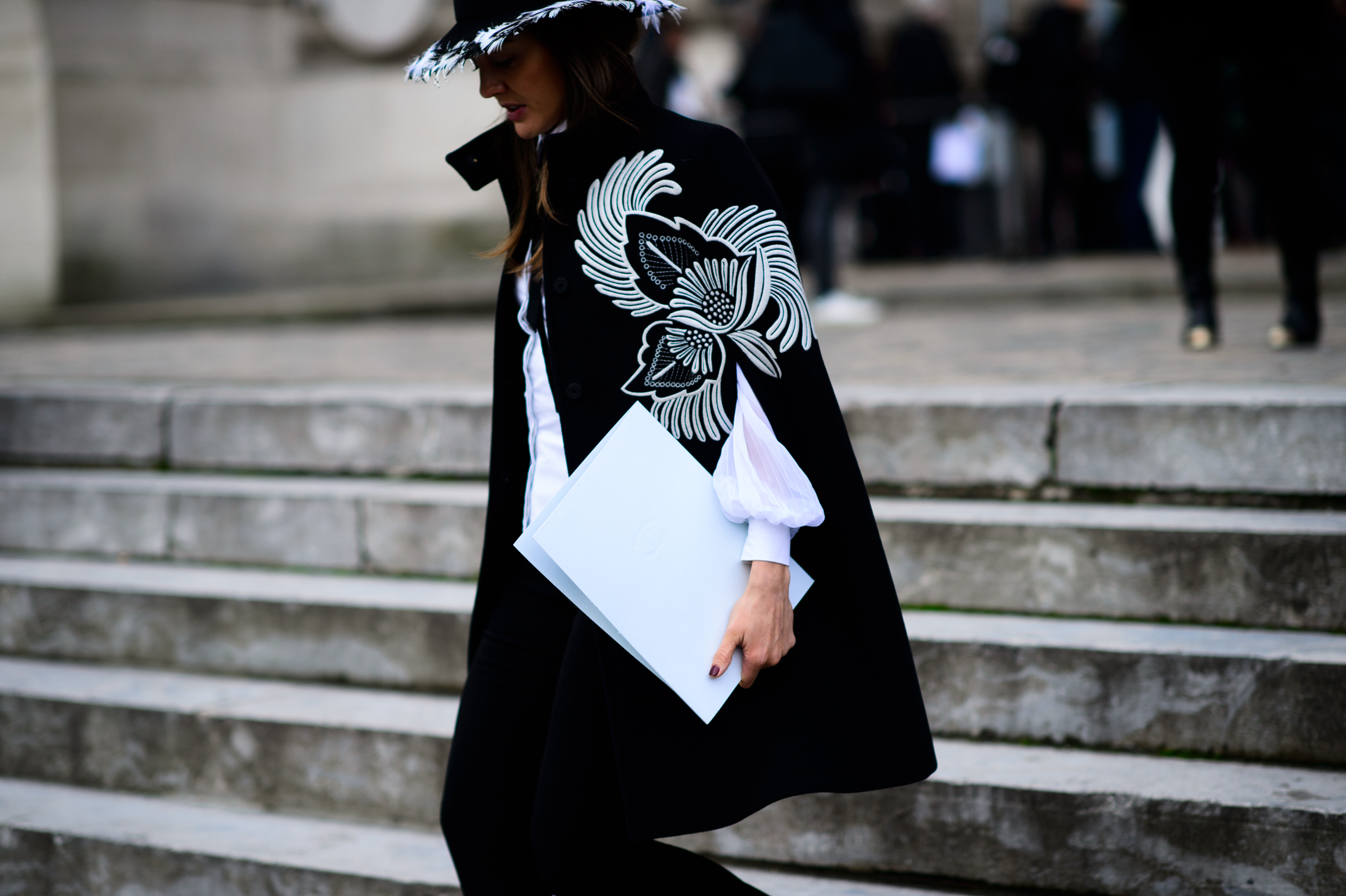 Woman wearing embroidered cape after the show