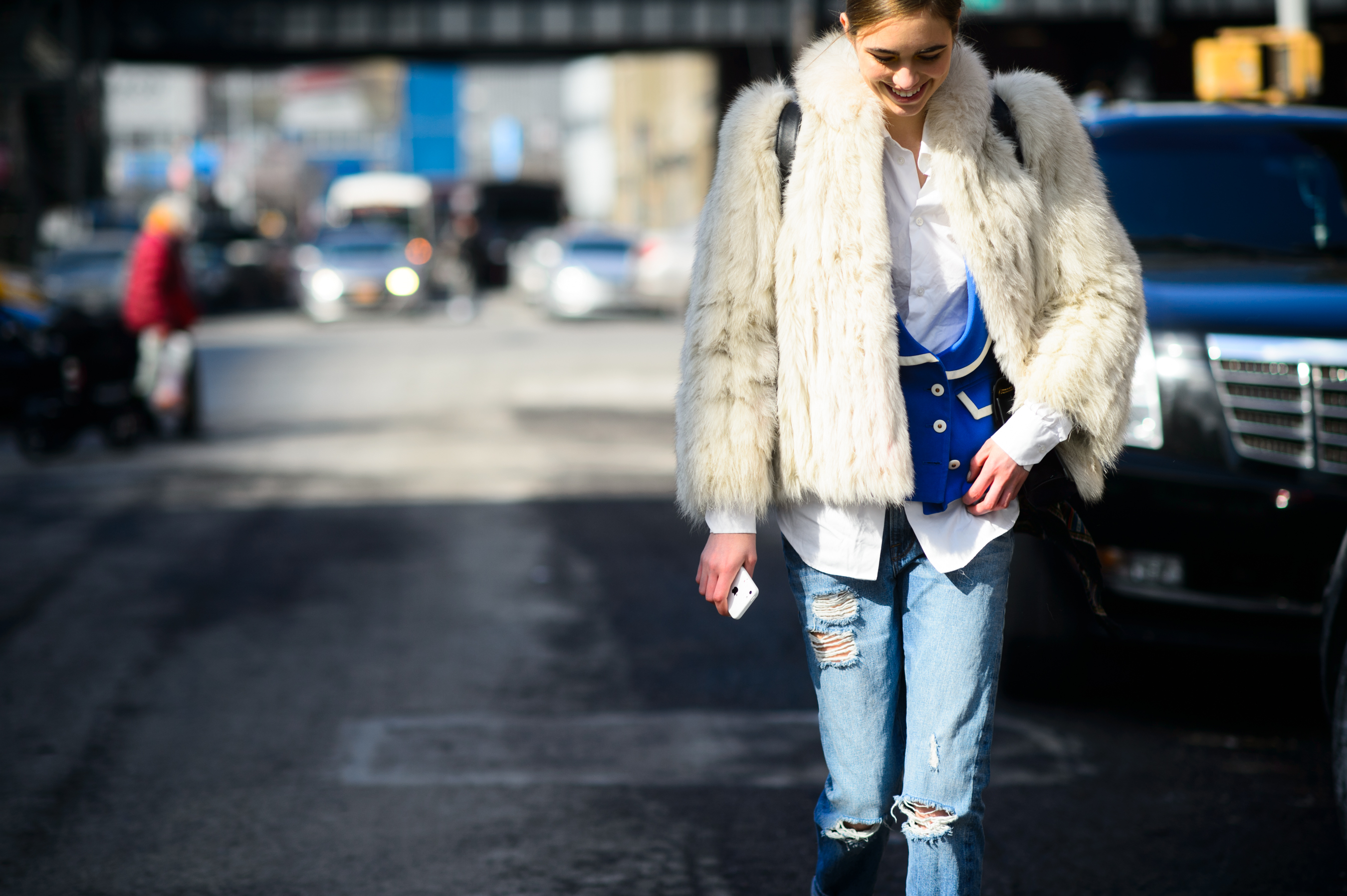 Model wearing white fur coat after the show