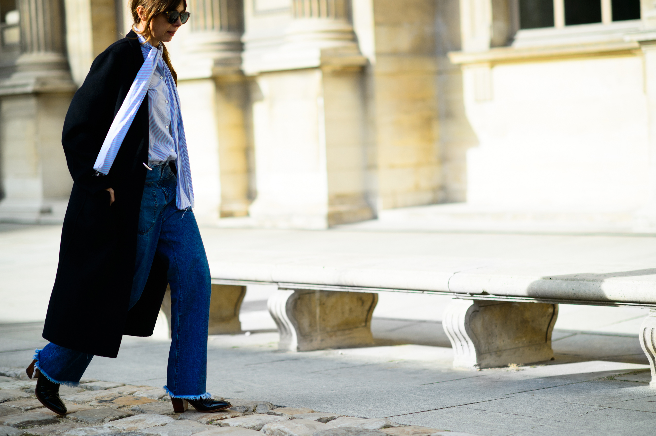 Woman wearing jeans and black coat