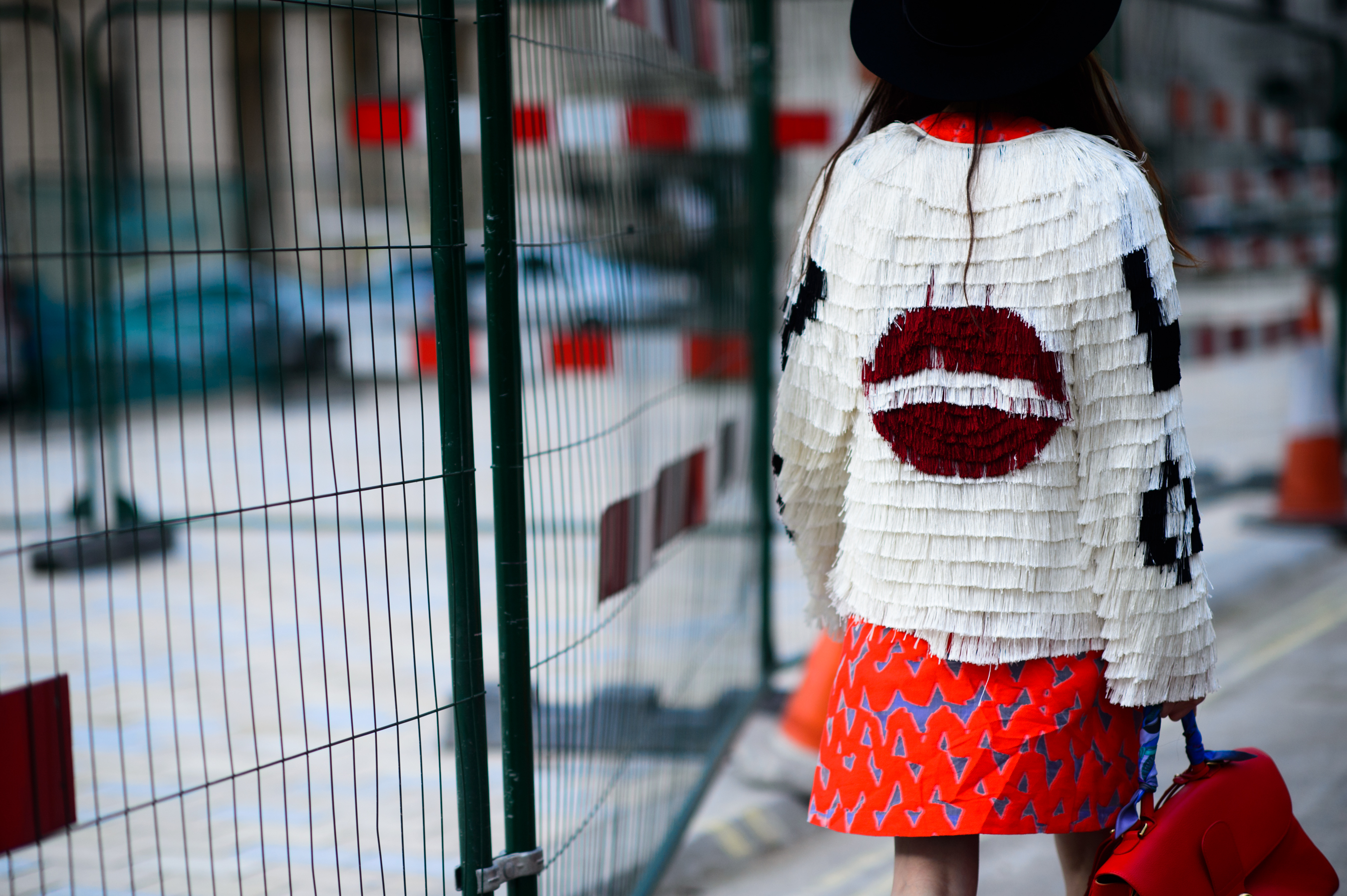 Girl wearing jacket with lips on the back
