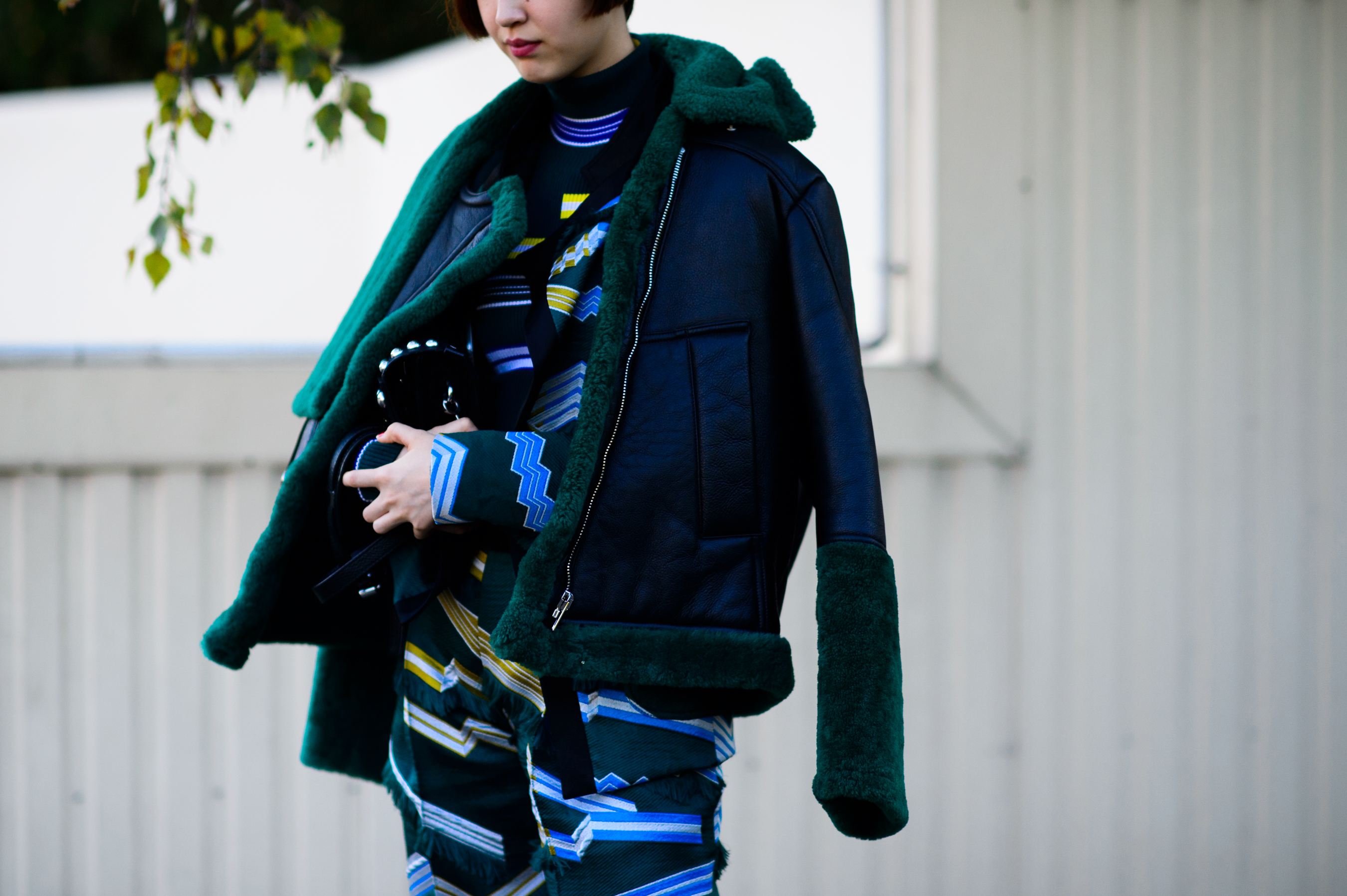 Woman wearing green sheepskin coat after the show