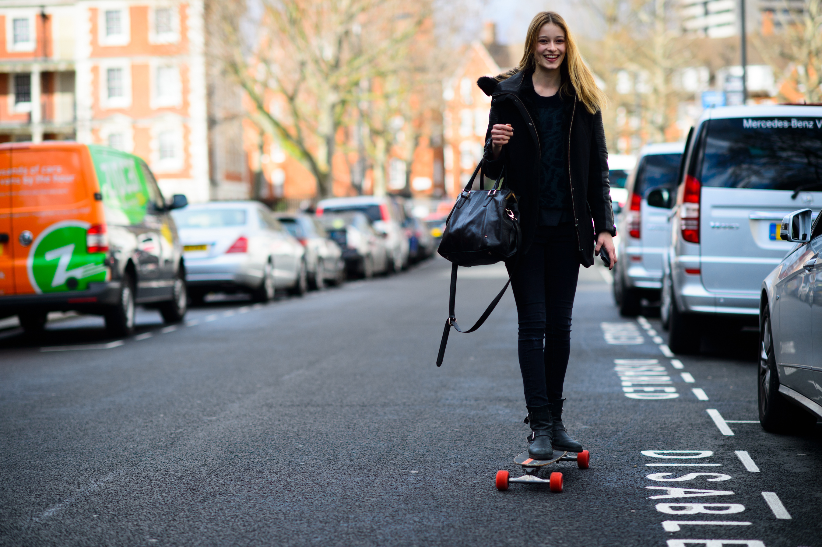 Model riding a longboard after the show