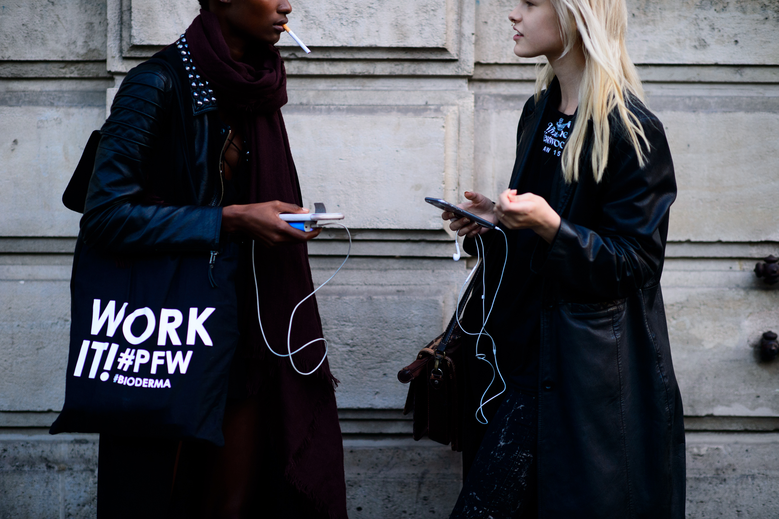 Two models wearing black after the show