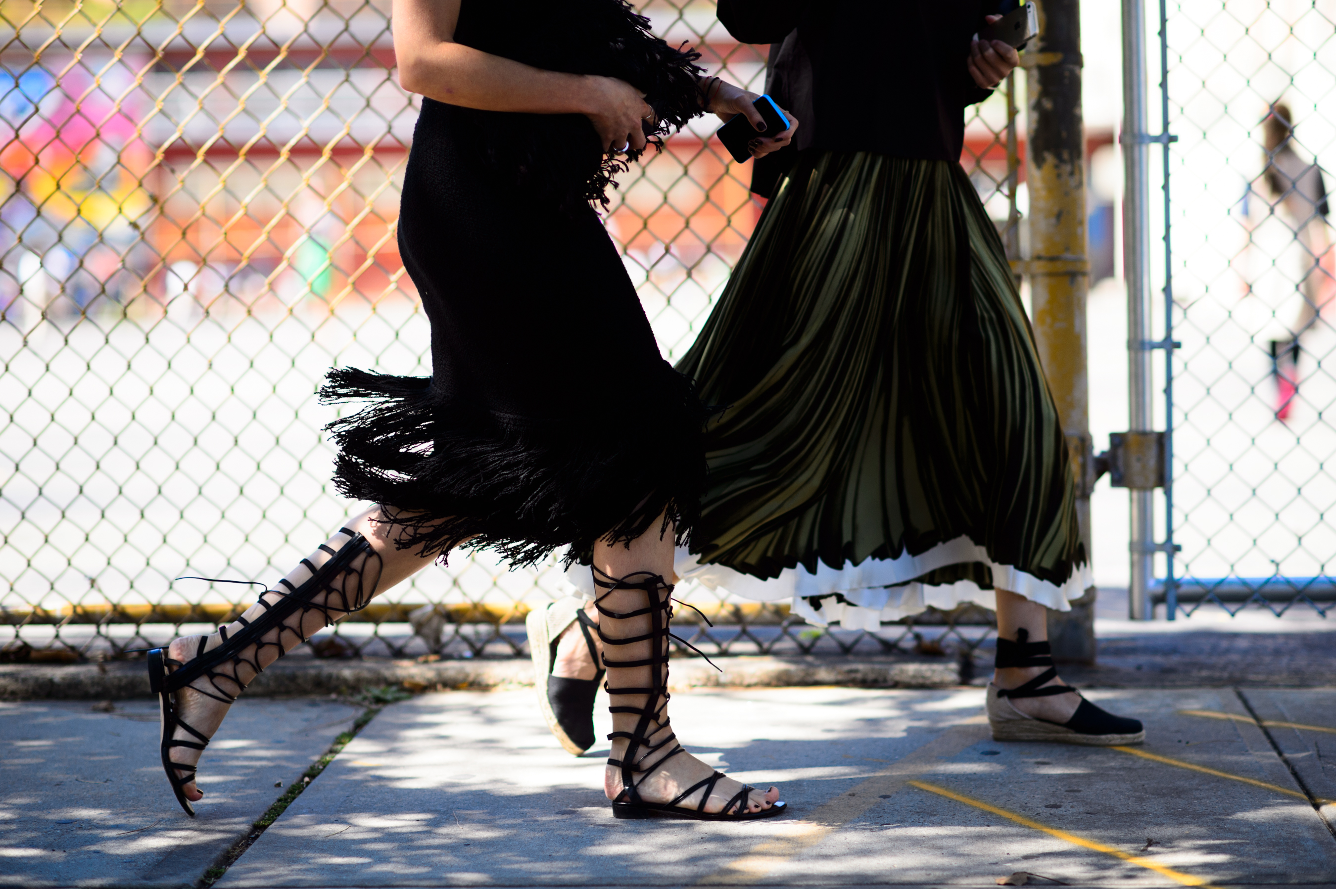 Two women walking in gladiator sandals