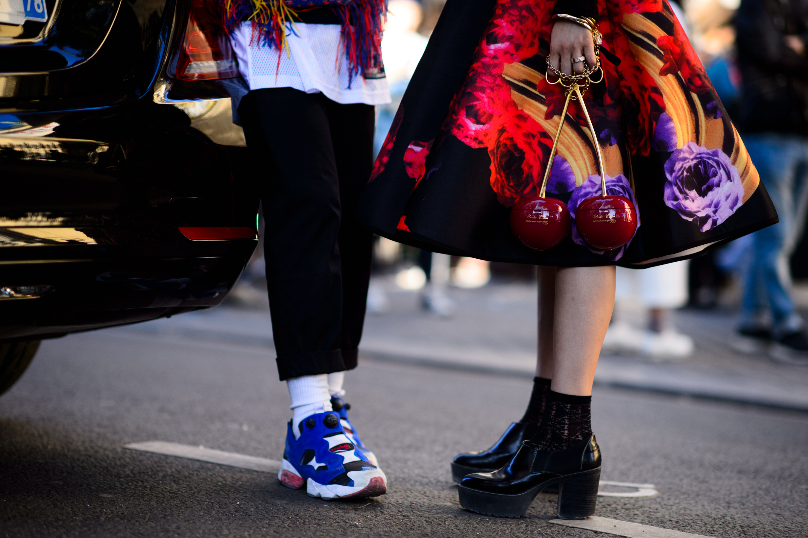 Close up of colorful sneakers and cherry shaped clutch