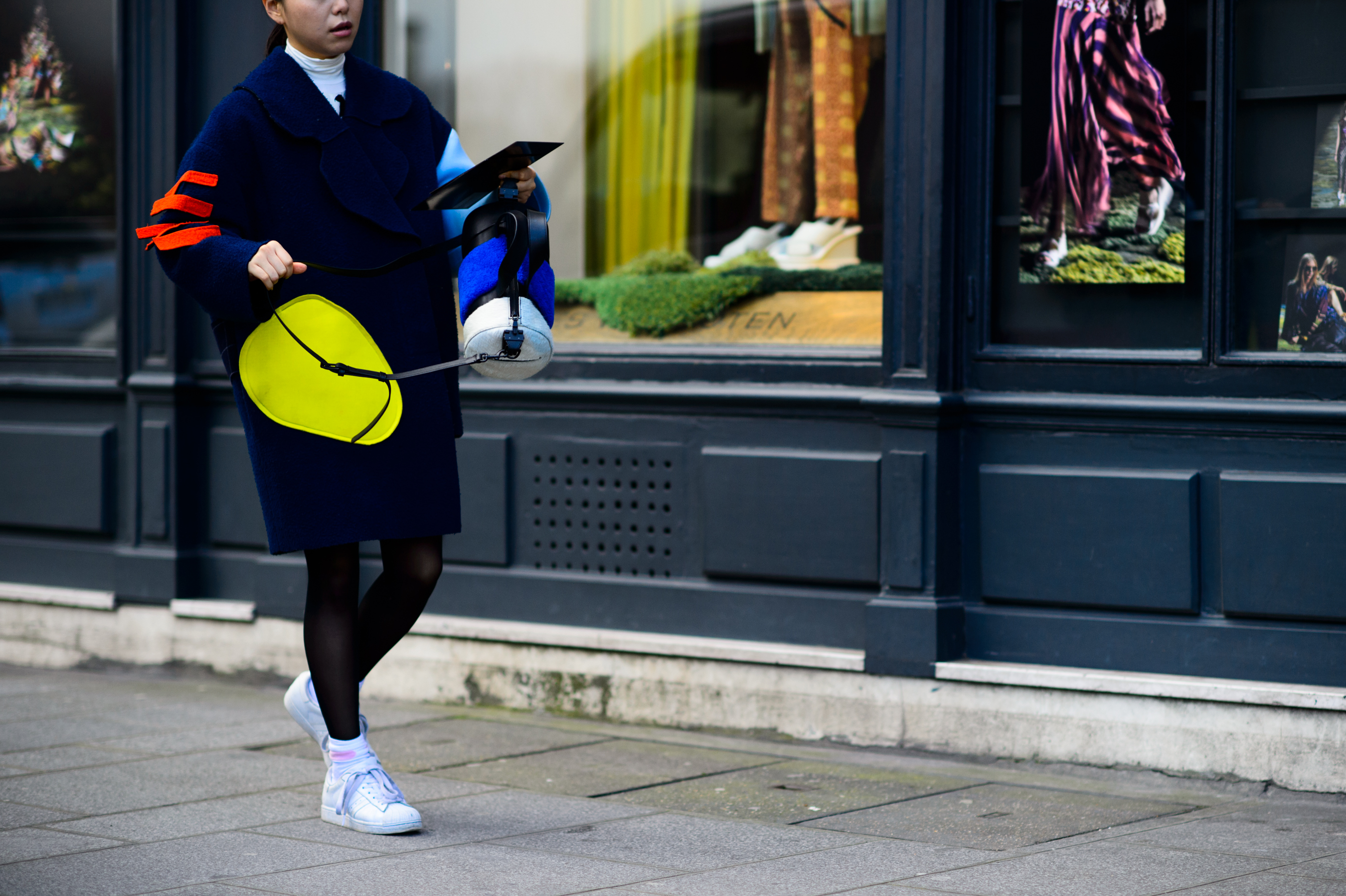 Woman wearing coat and sneakers