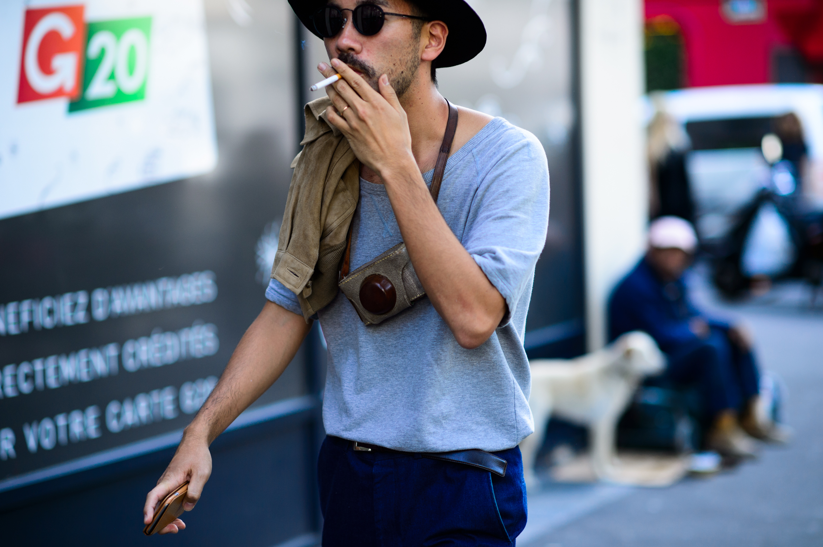 Man wearing hat and glasses smoking