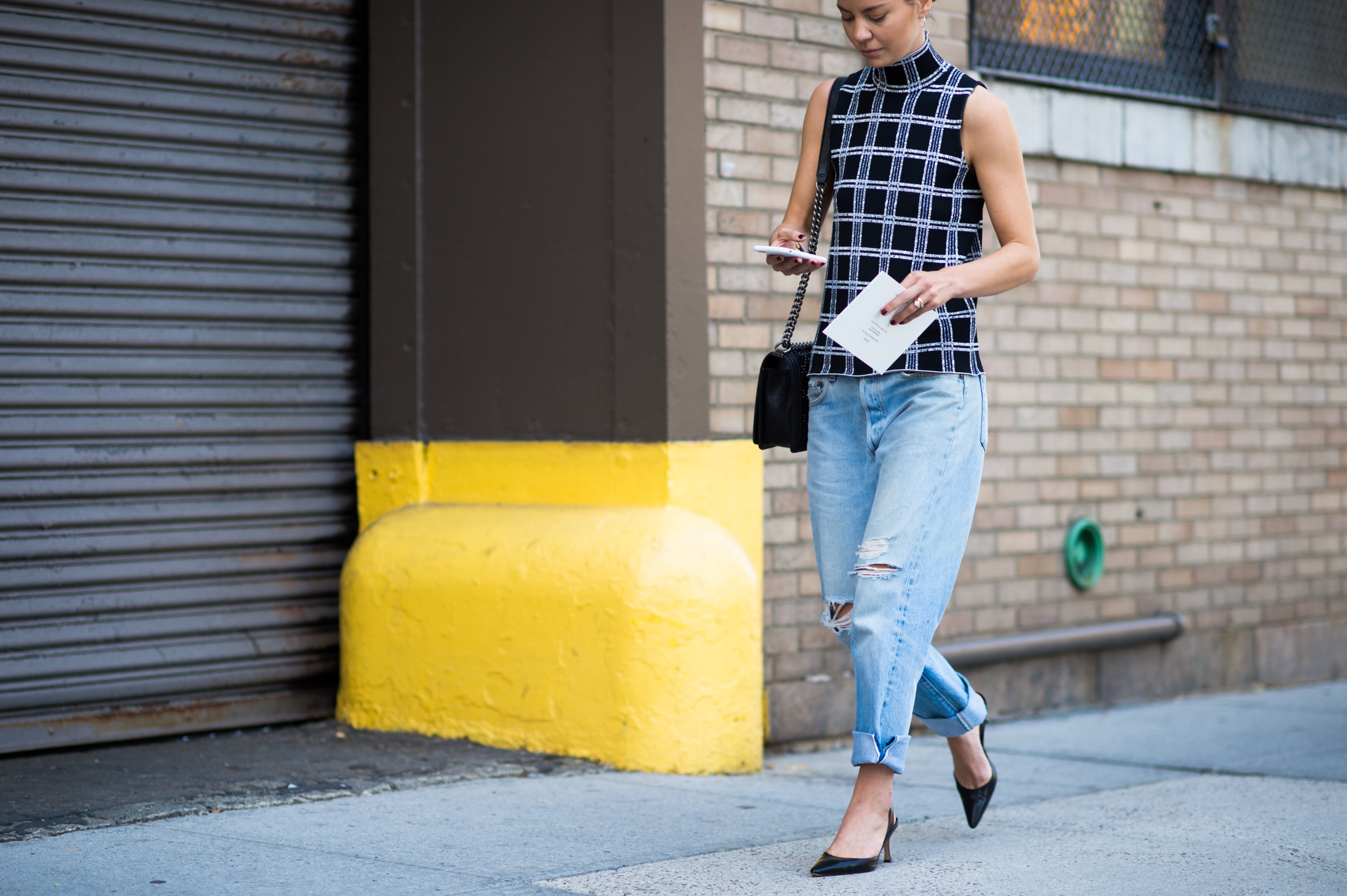 Woman wearing jeans and sleeveless top