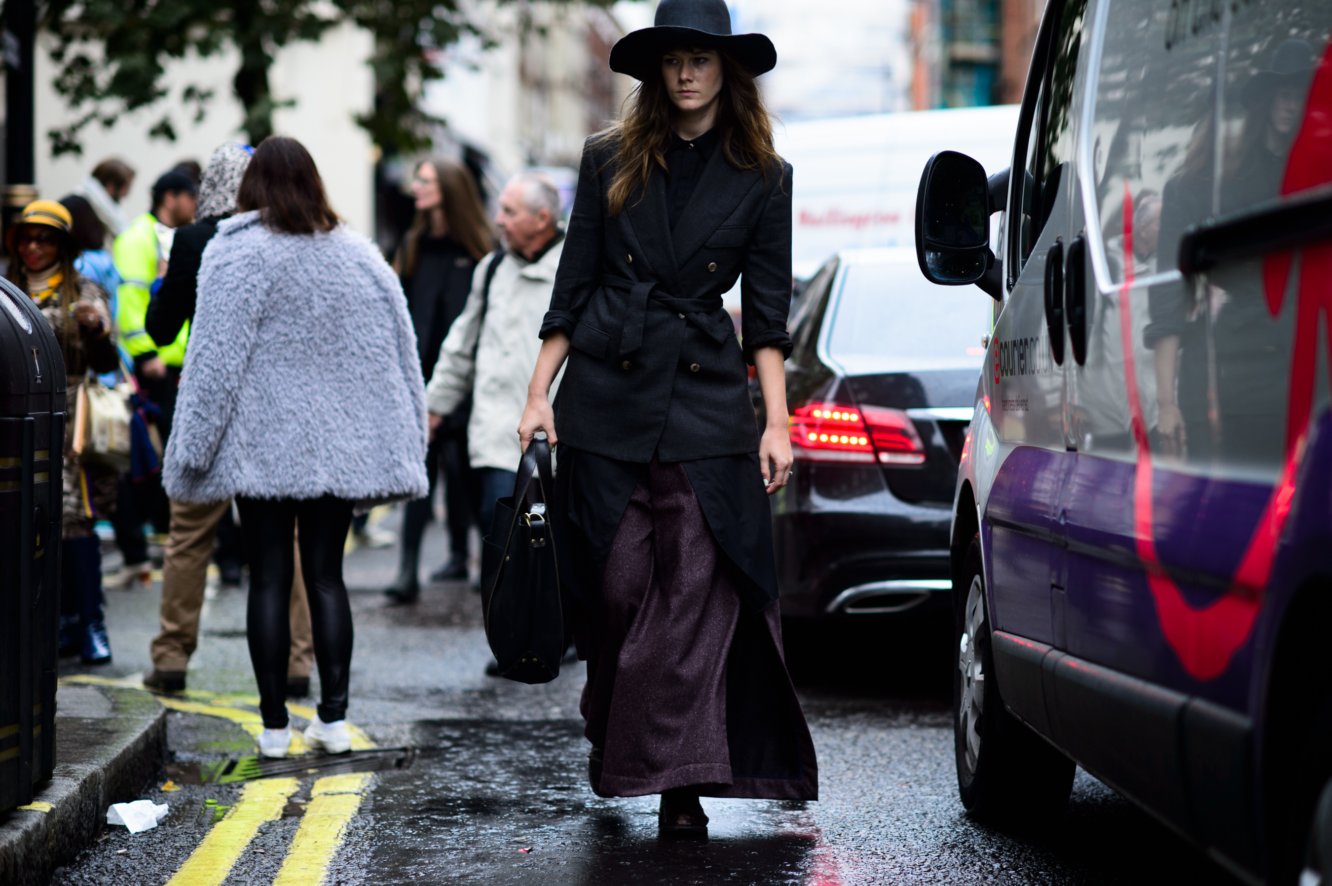 Canadian editor wearing hat and dark outfit