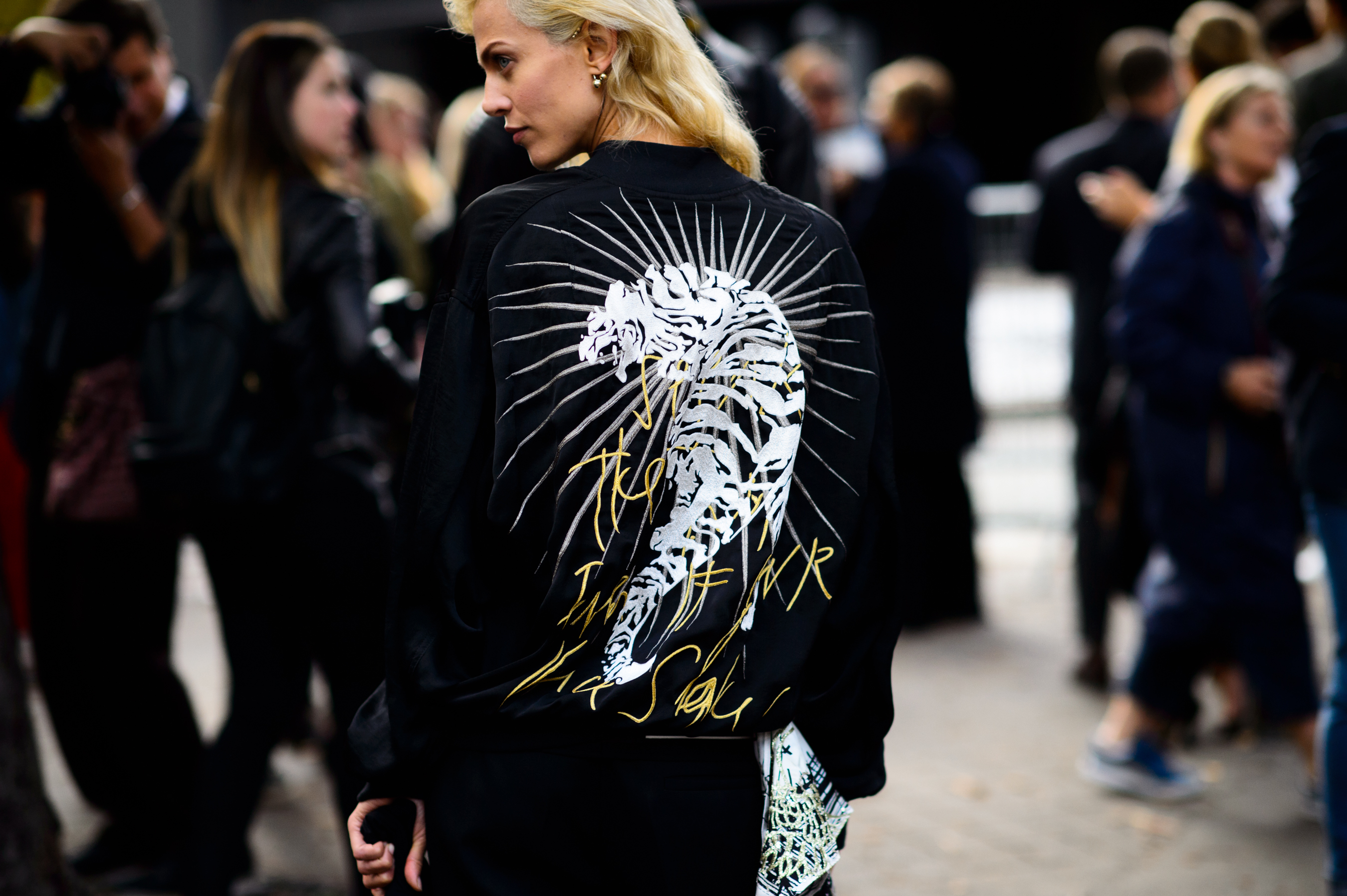 French top model wearing black bomber with tiger on the back