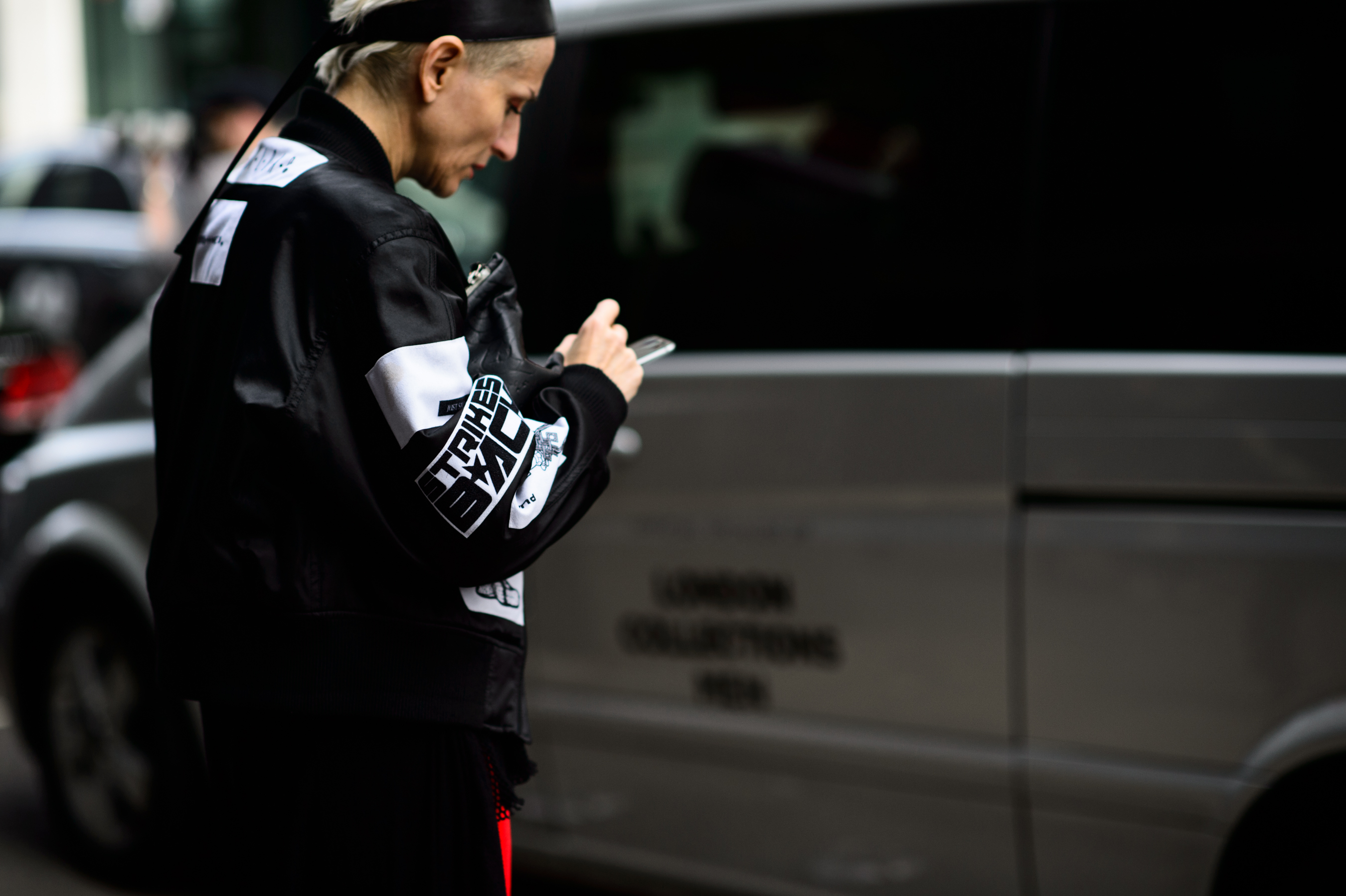 Woman in black racing jacket with short silver hair