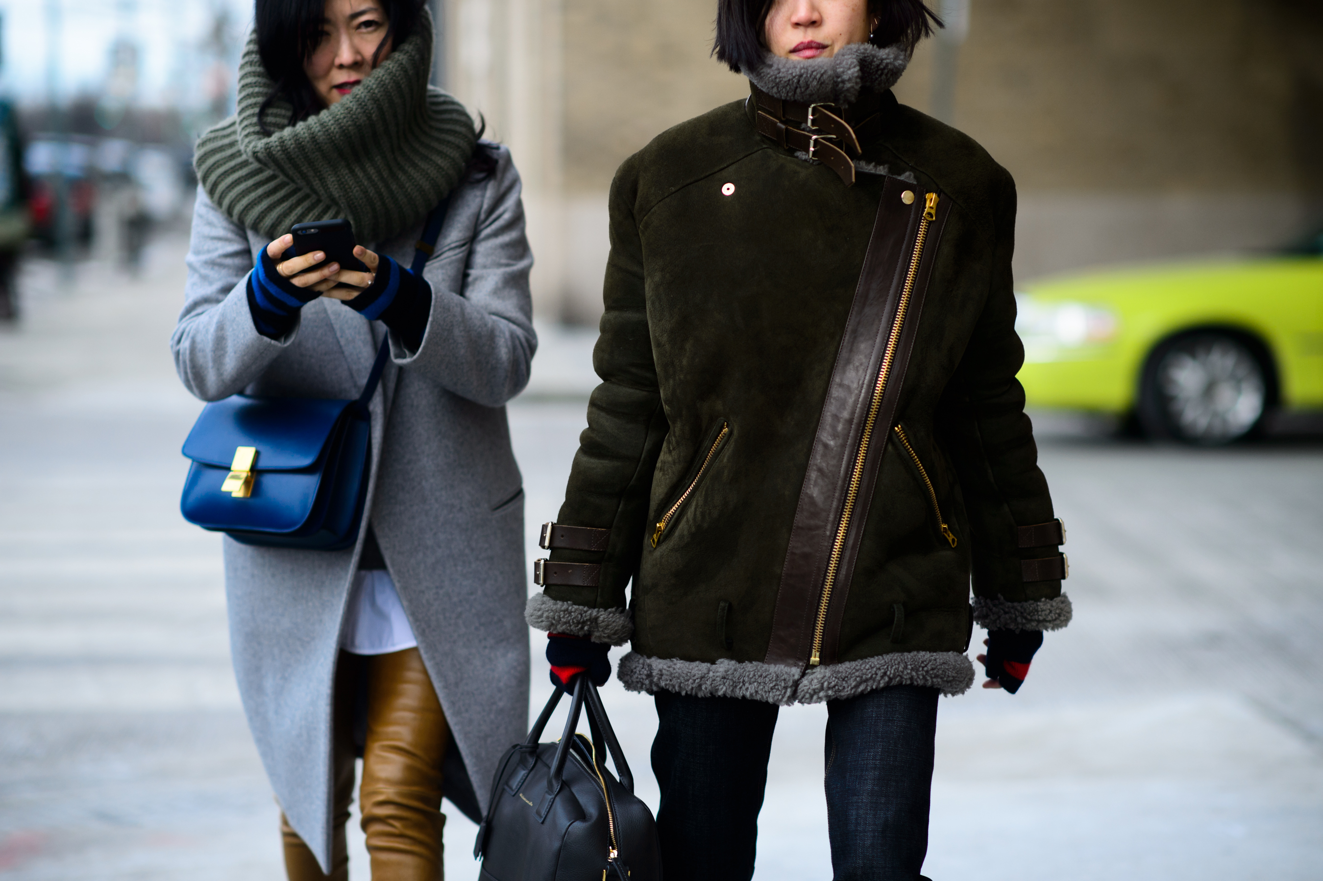 Two Asian women dressed warm before the show