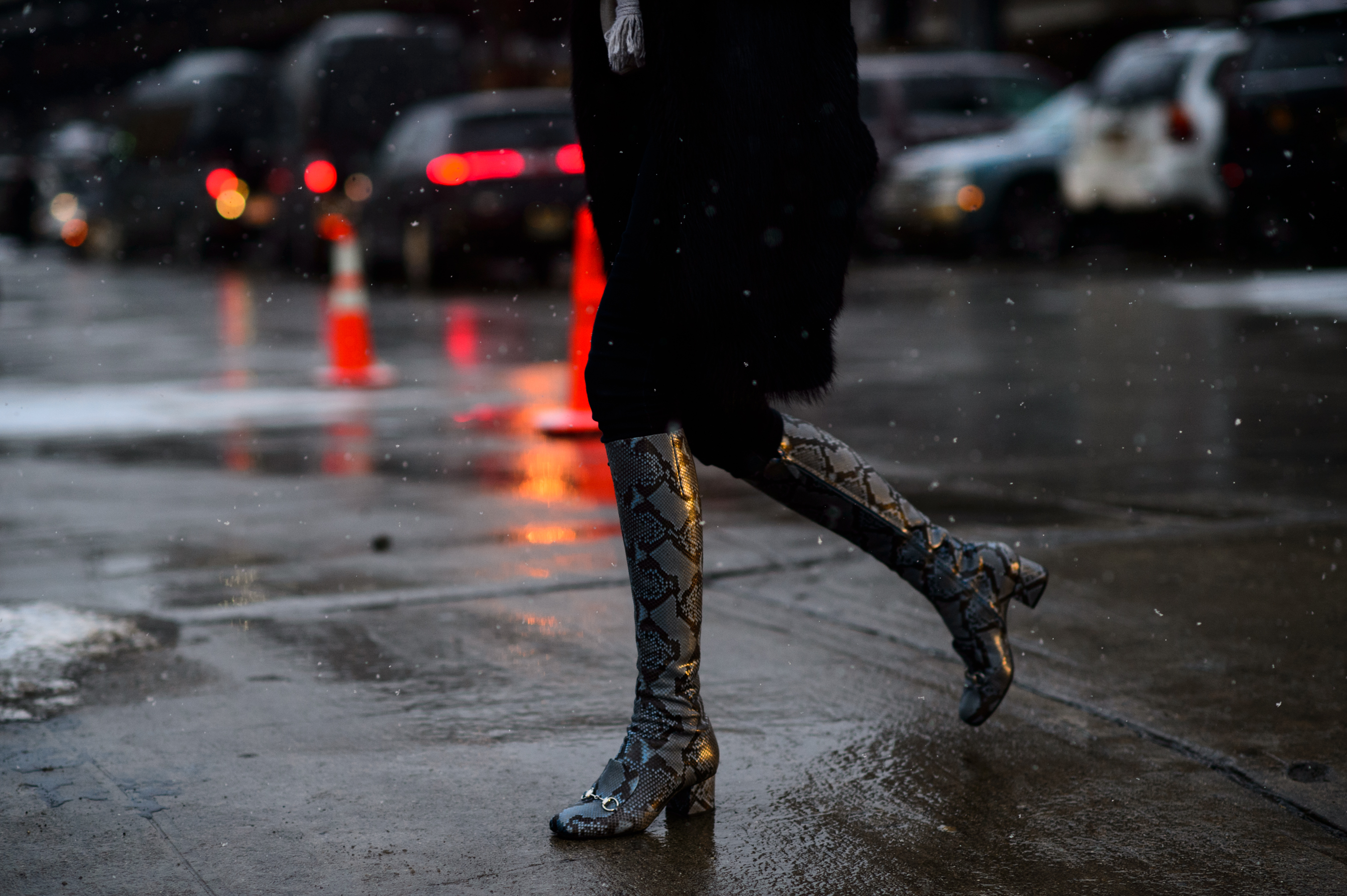 Woman wearing high snakeskin boots