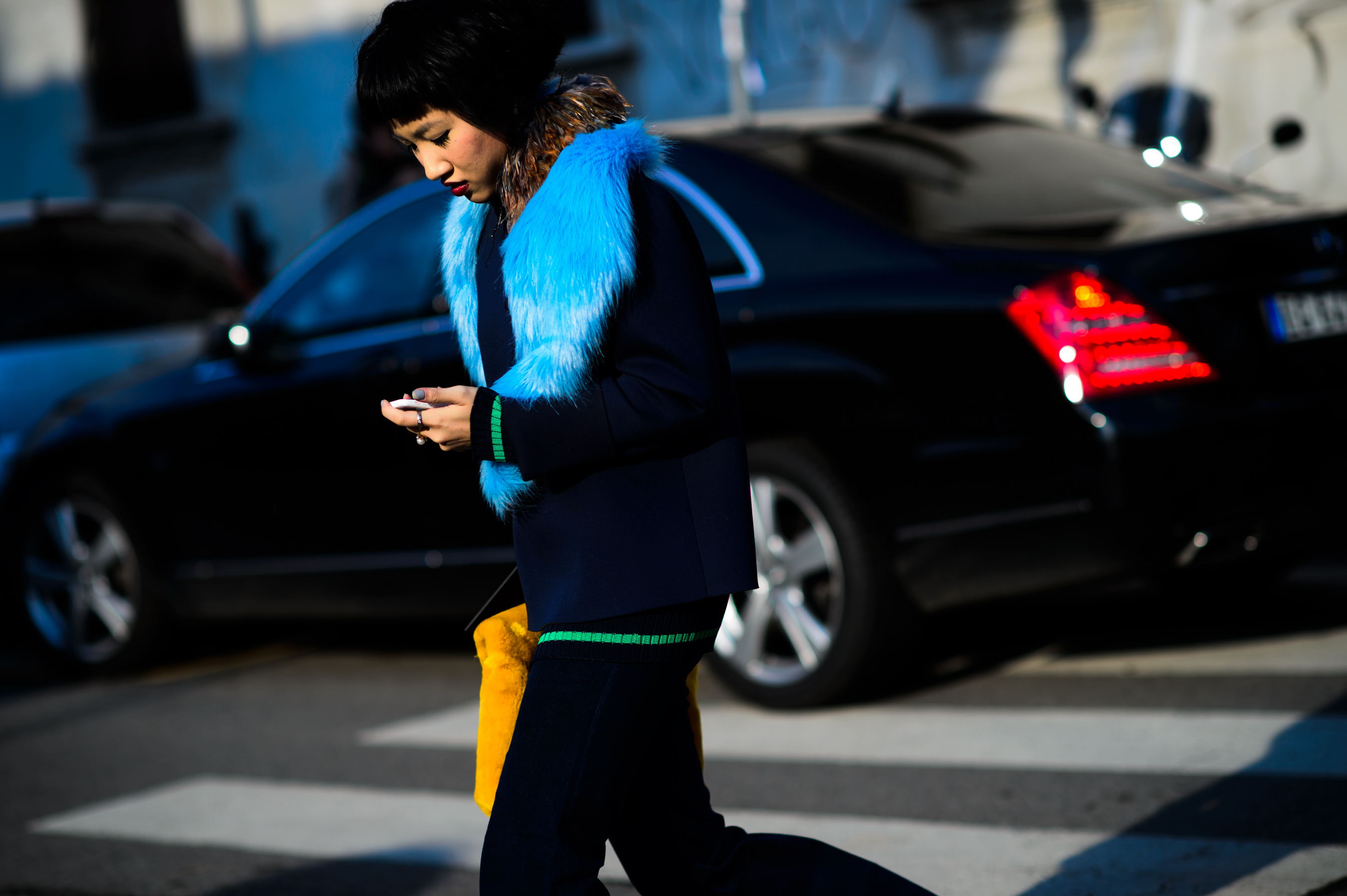 Woman with short black hair crossing the road