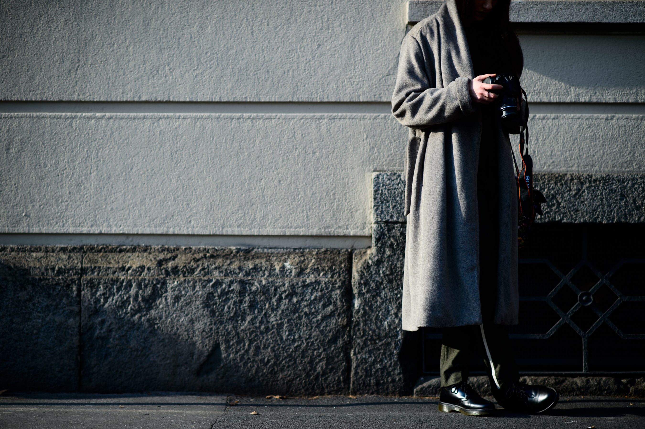 Female photographer wearing grey coat