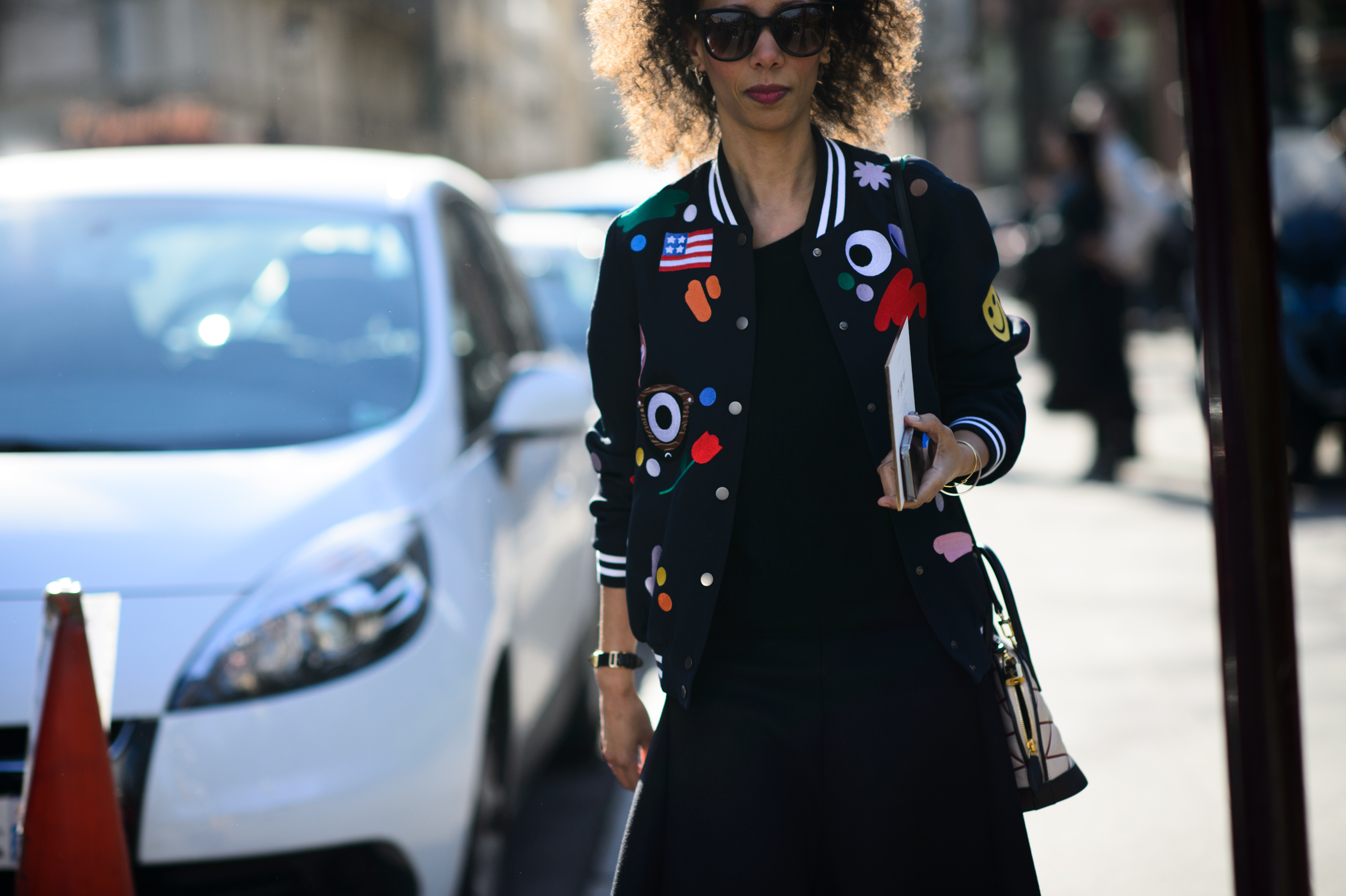 Woman wearing bomber with patches