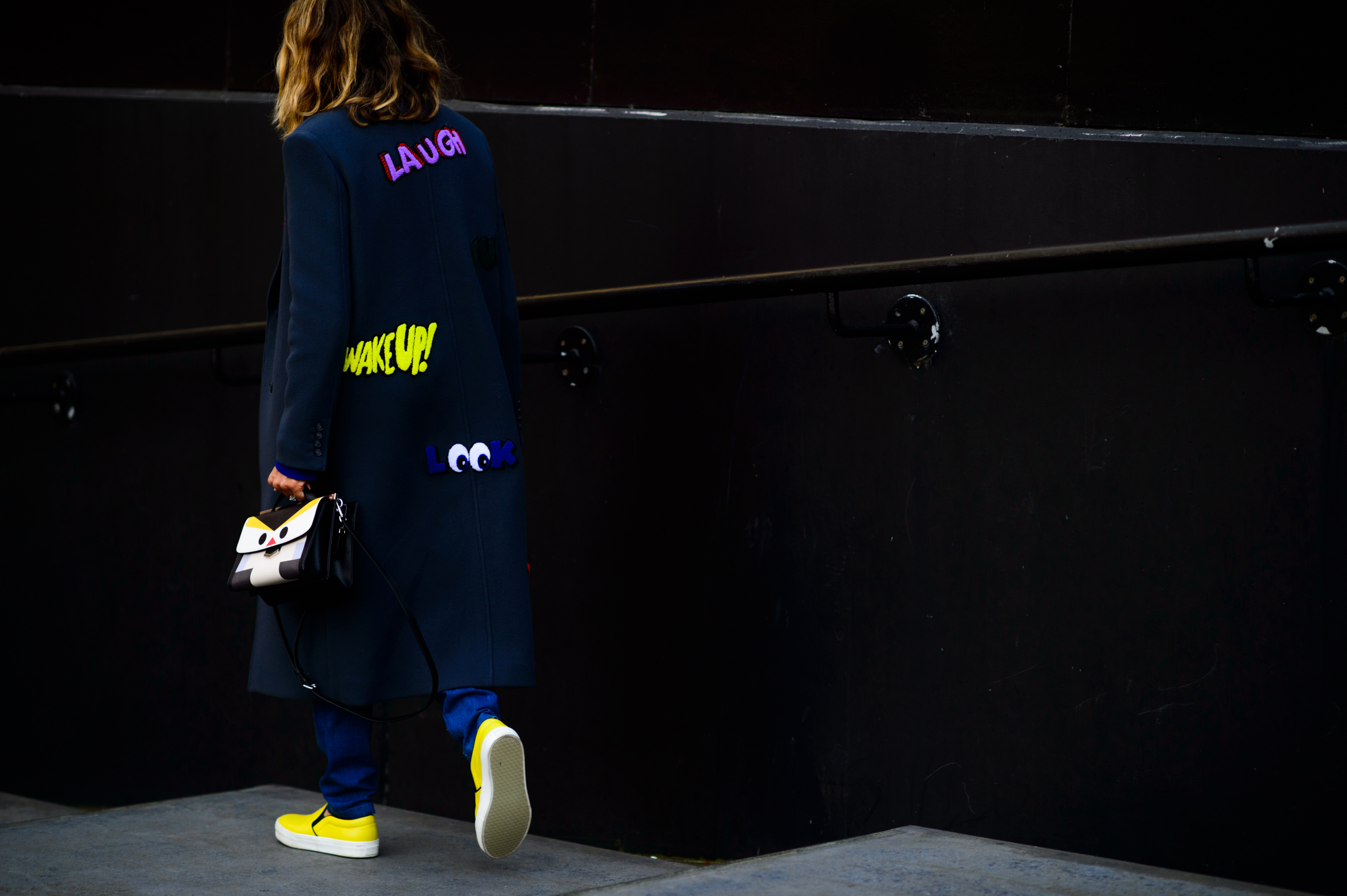 Woman wearing coat with slogans