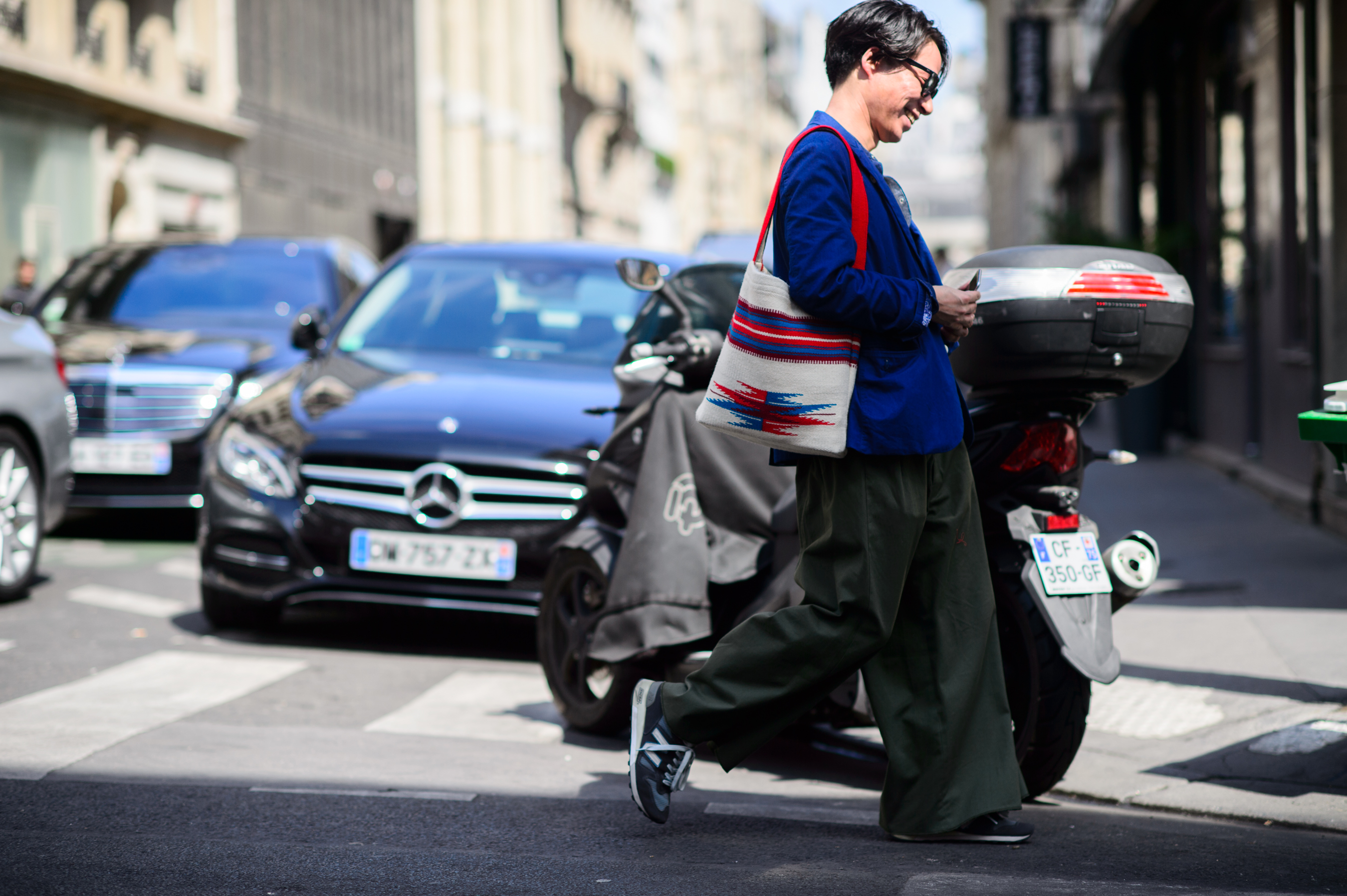 Man crosses the road wearing wide pants