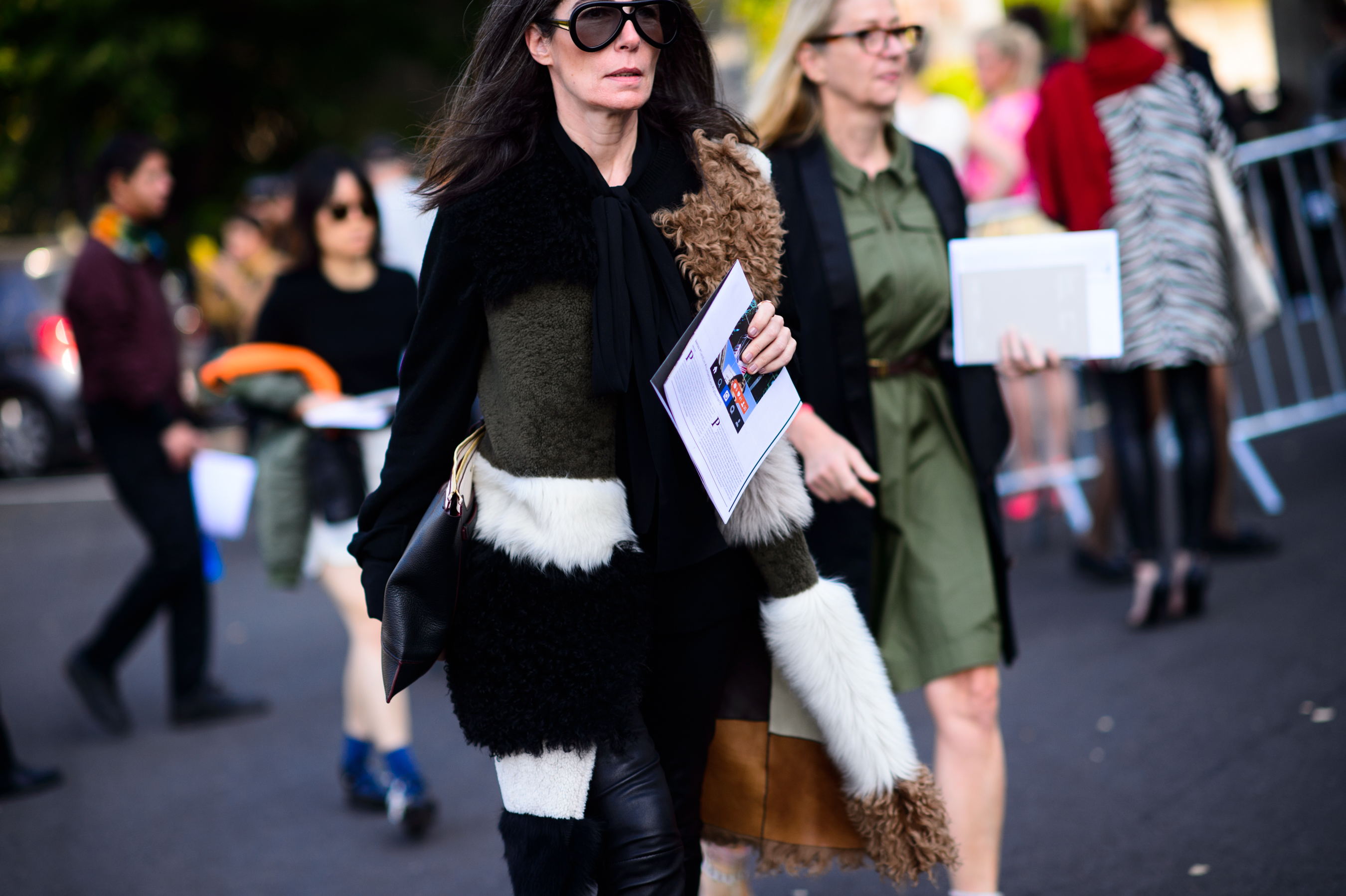 Woman wearing fur coat and glasses before the show