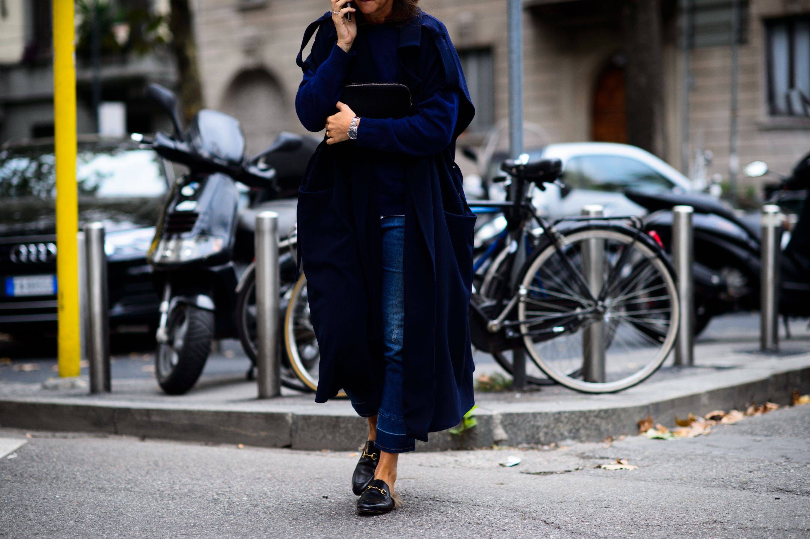 Woman wearing furry loafers crossing the street