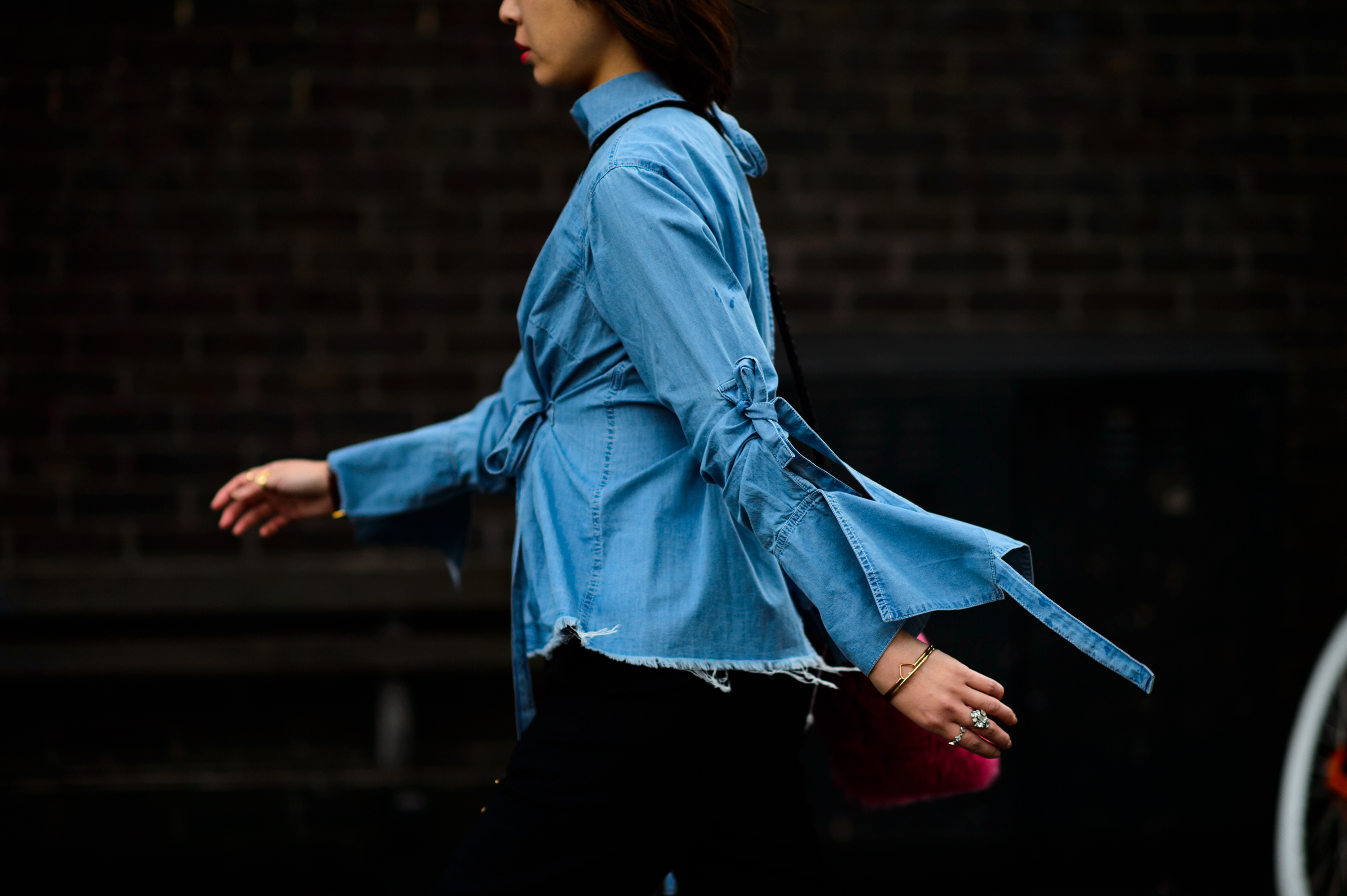 Woman wearing denim shirt with complex sleeves