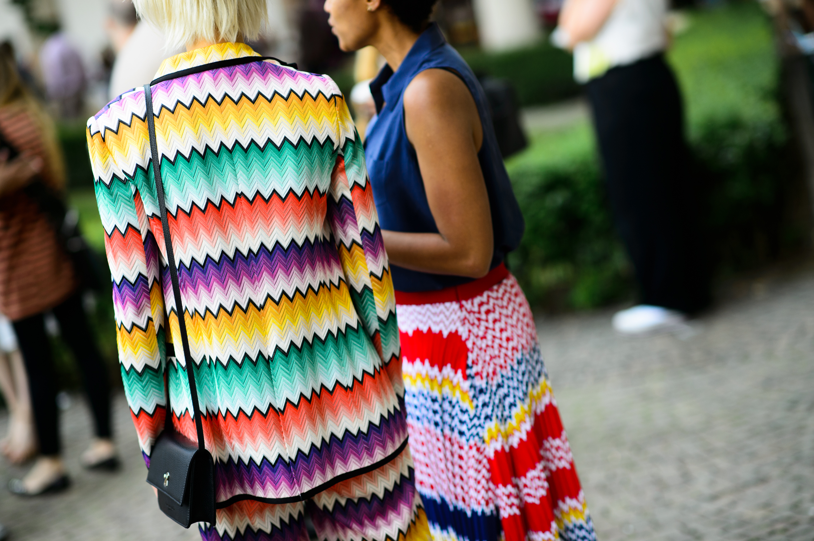 Two women wearing graphic outfit