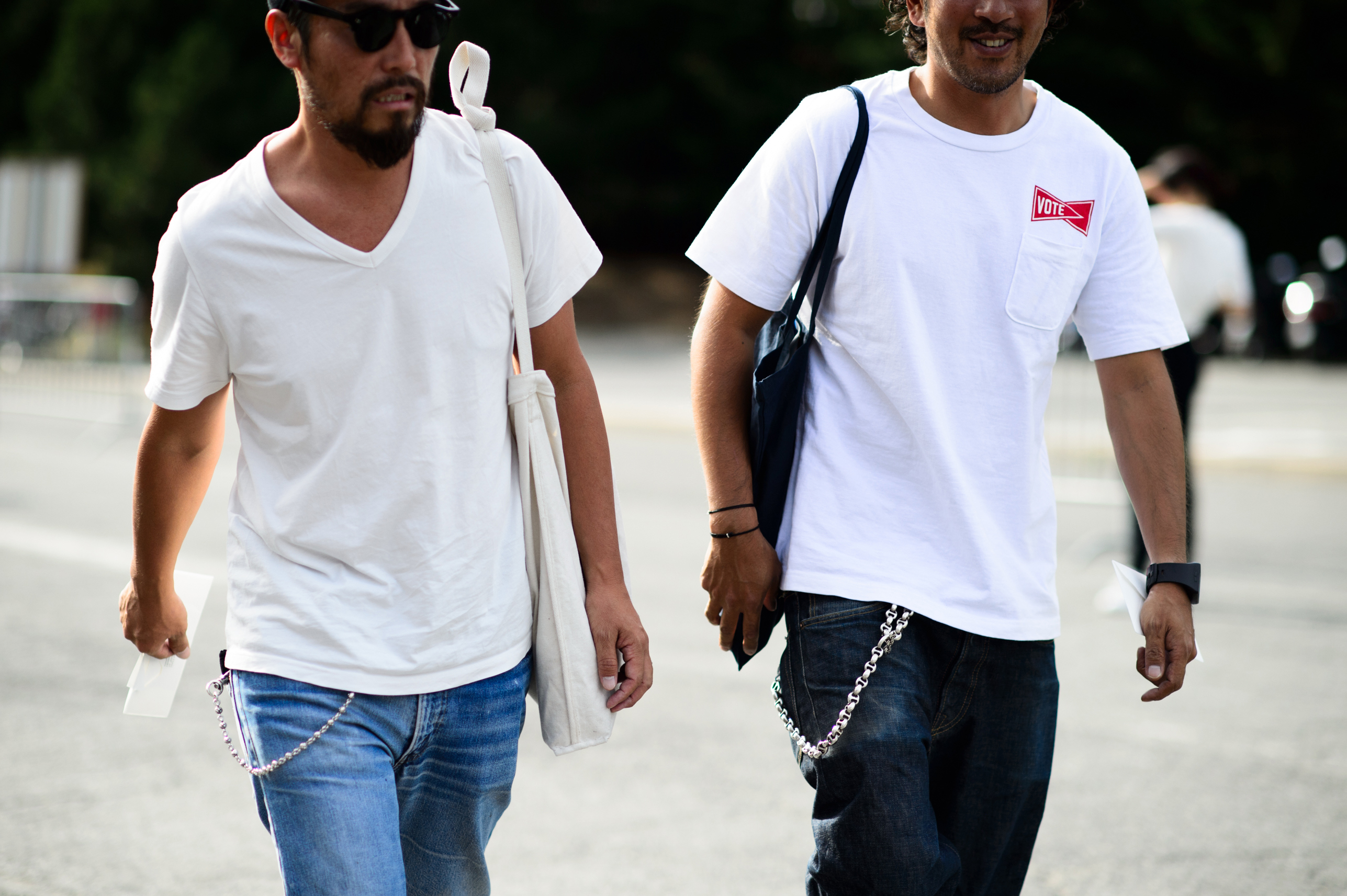 Two men in white t-shirts and chains on their jeans